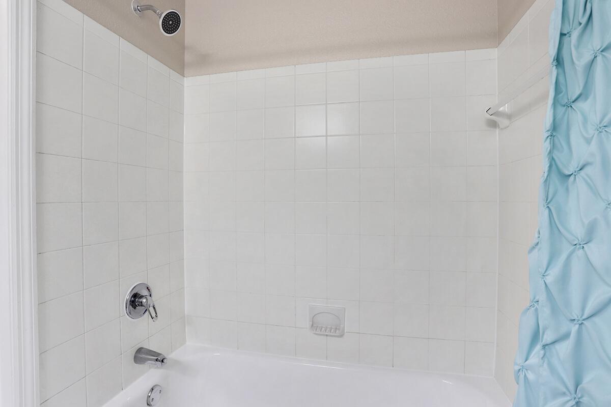 a white tub sitting next to a shower