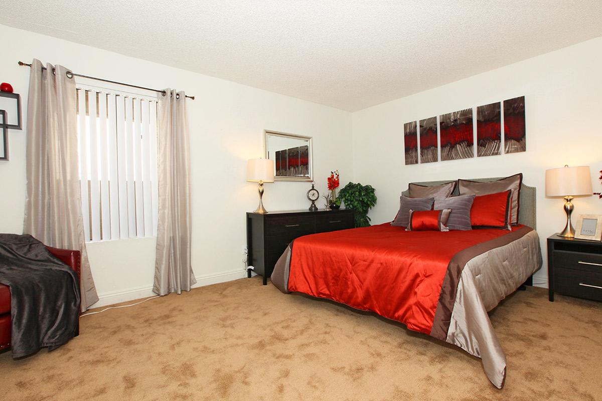 a bedroom with a large red bed in a room