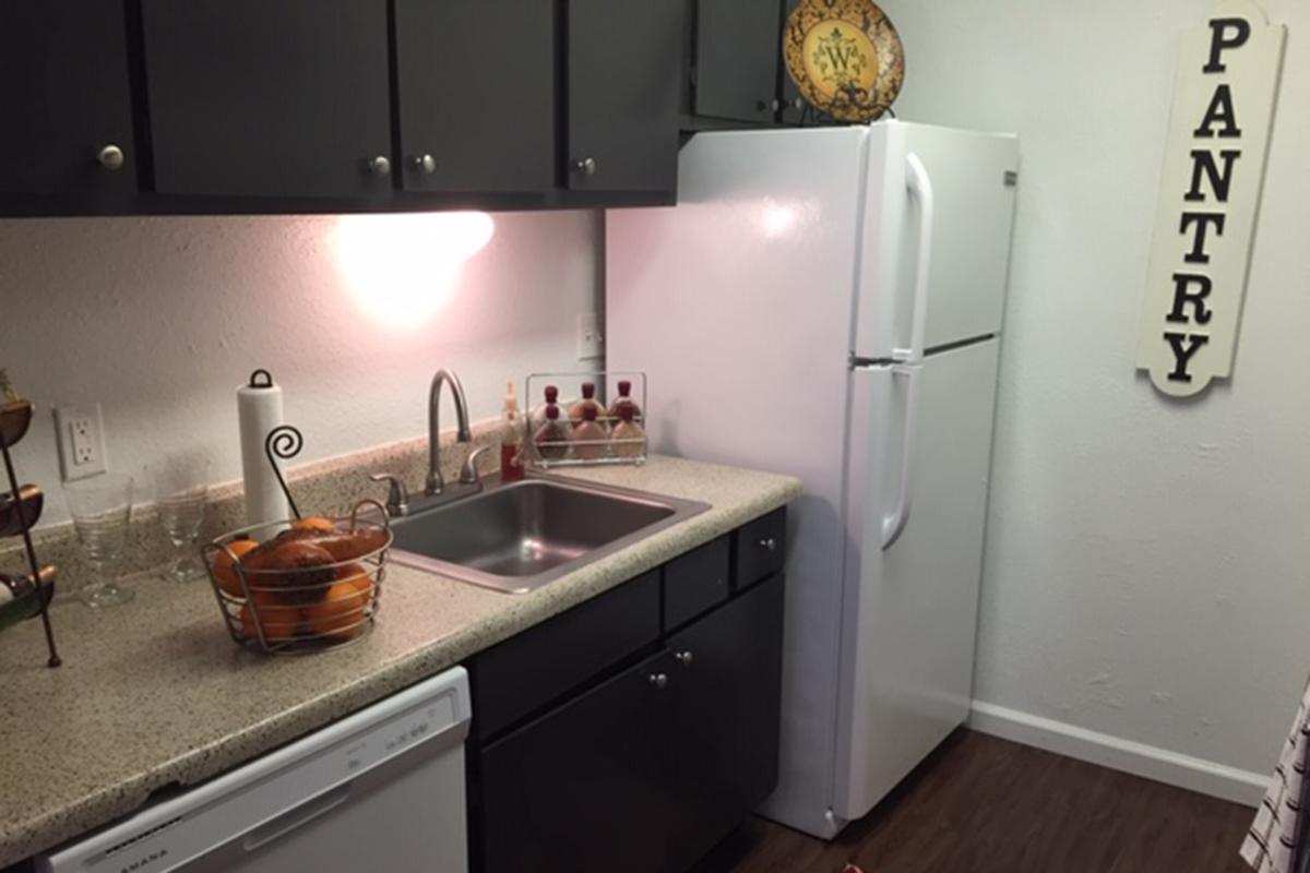 a kitchen with a sink and a mirror