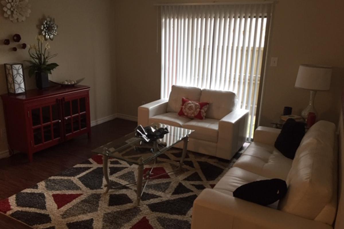 a living room filled with furniture and a window