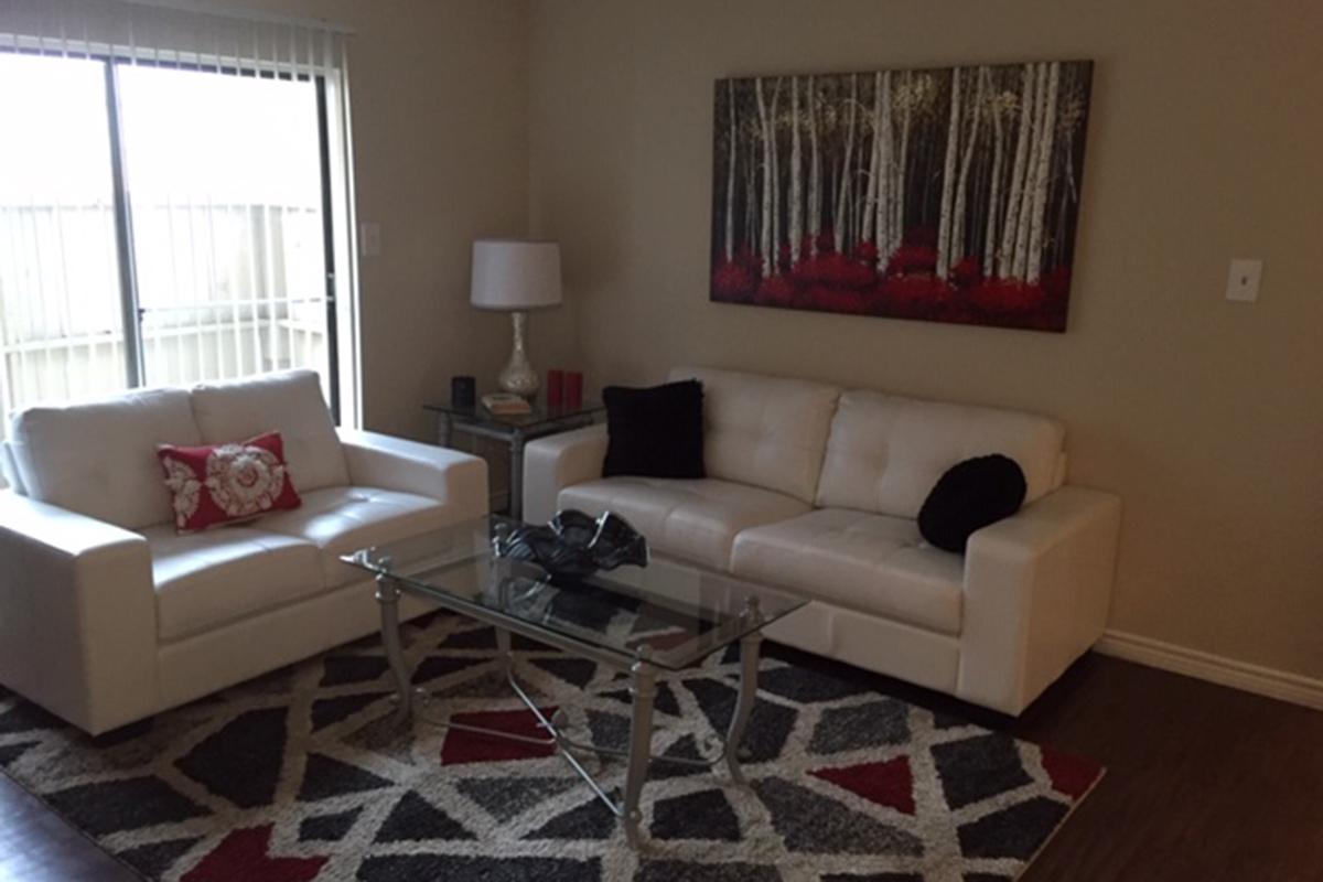 a living room with a red rug