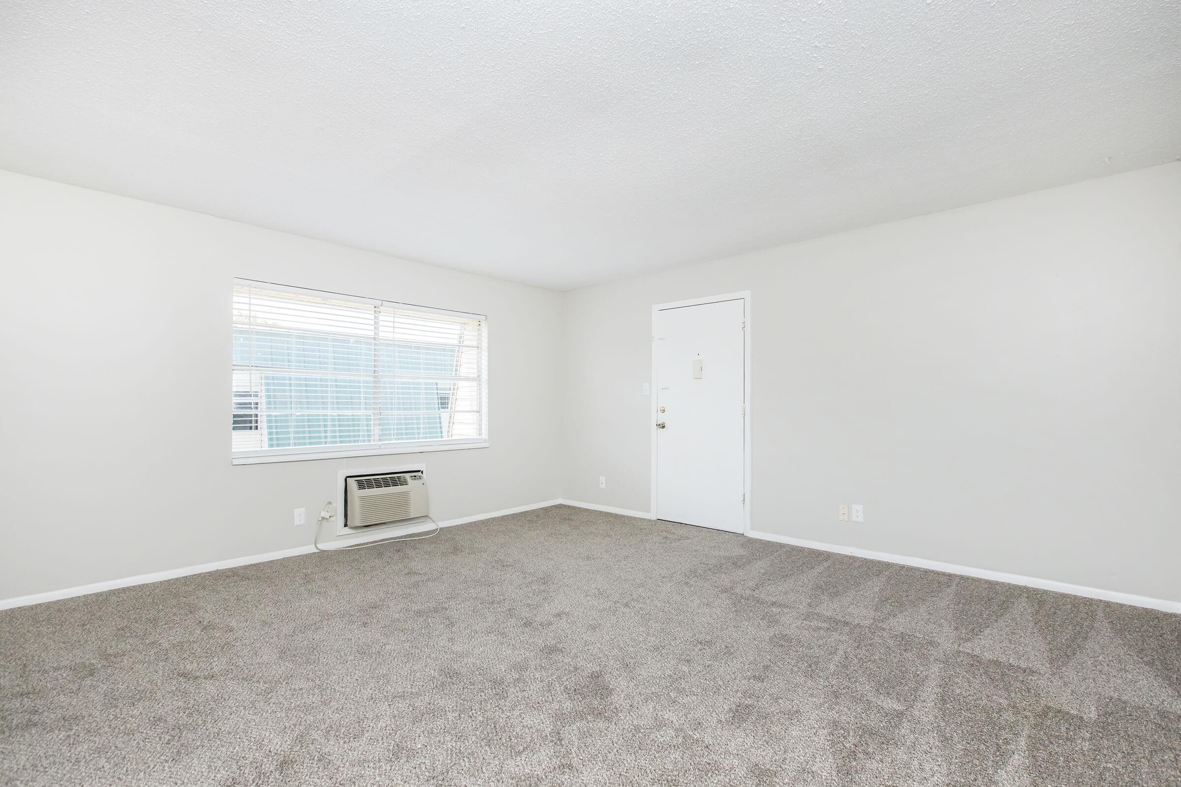 a bedroom with a large window