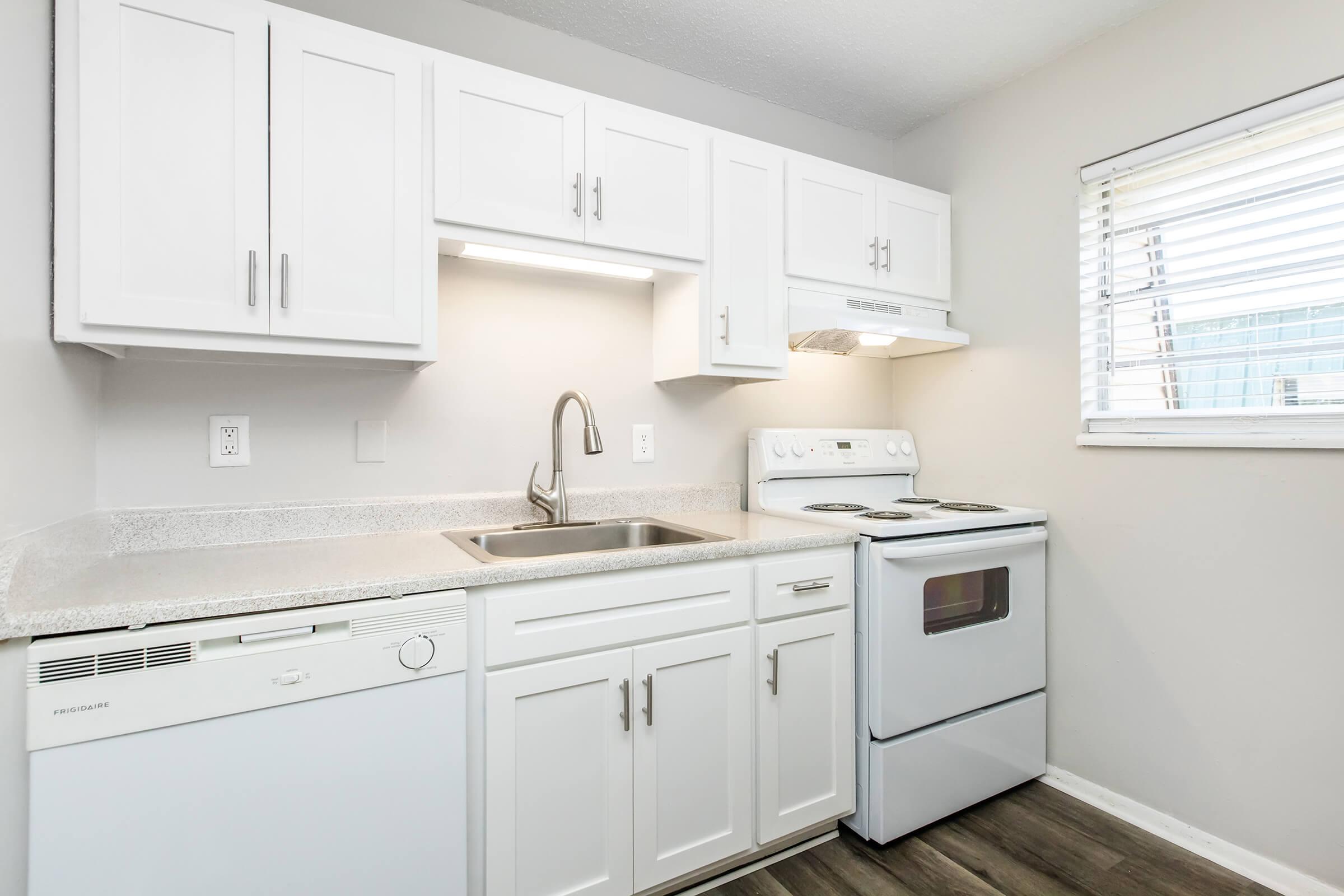 a stove top oven sitting inside of a kitchen