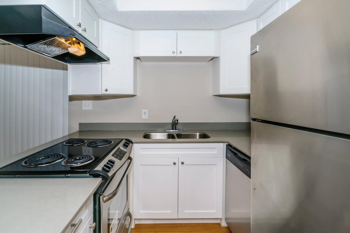 a stove top oven sitting inside of a kitchen