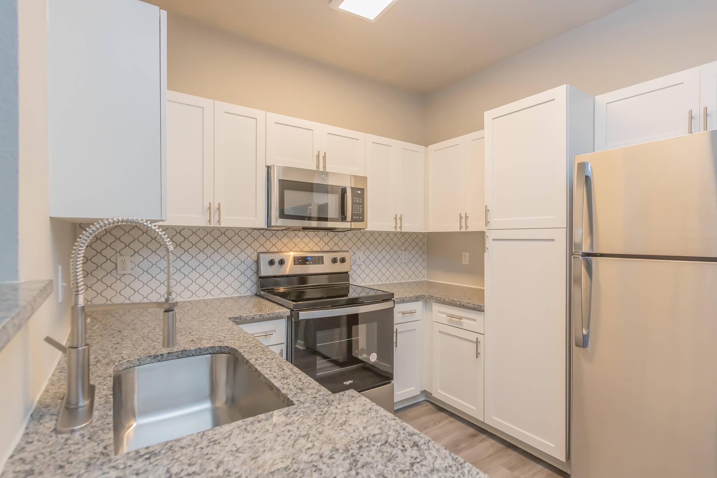 a kitchen with a sink and a refrigerator