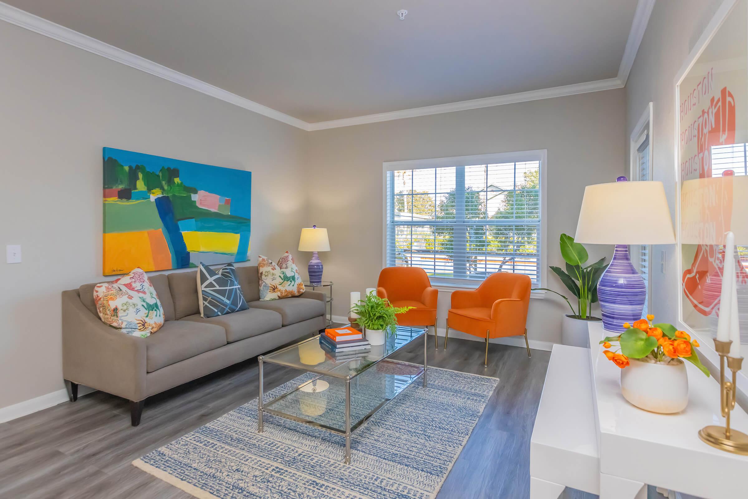 a living room filled with furniture and a large window