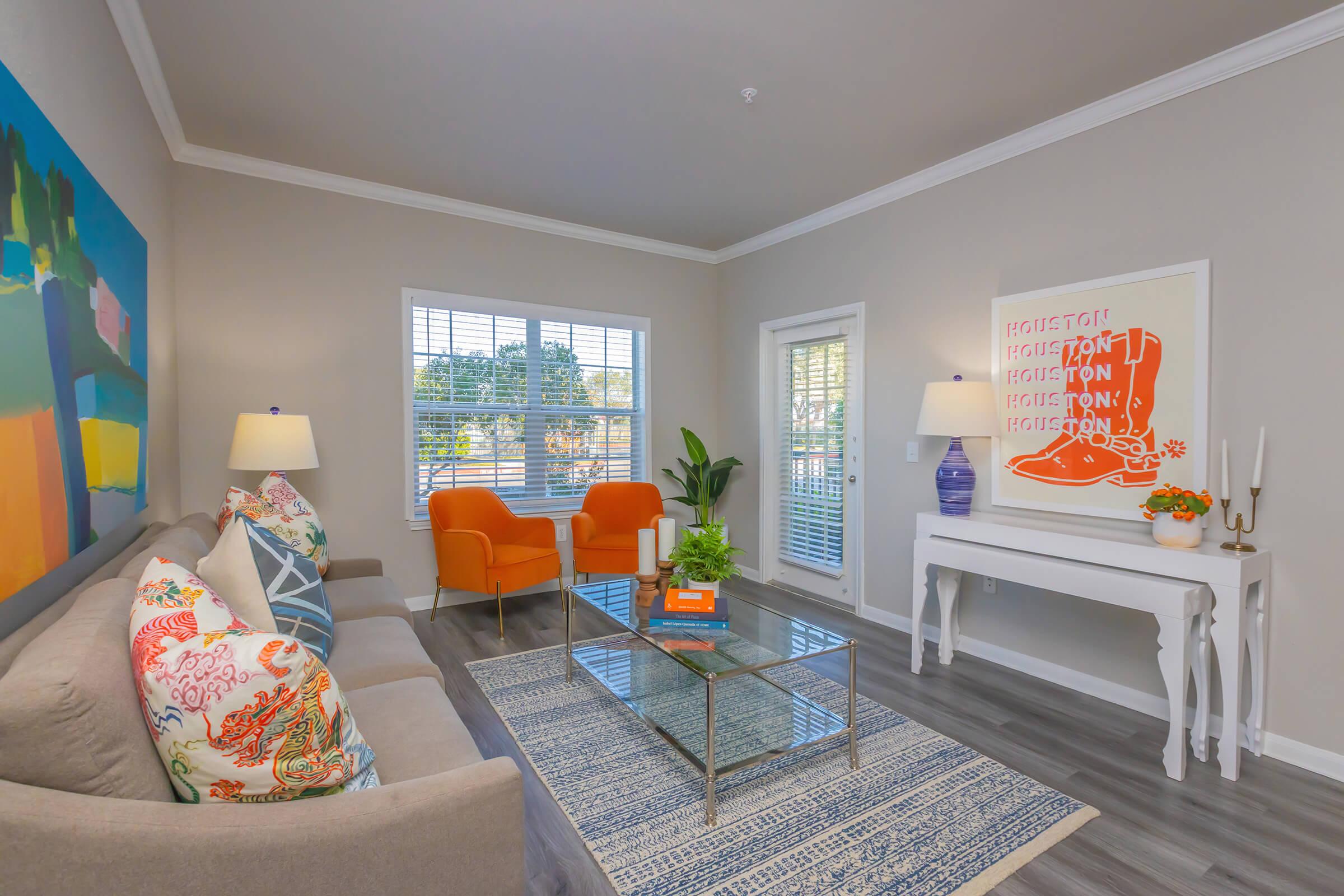 a living room filled with furniture and a large window