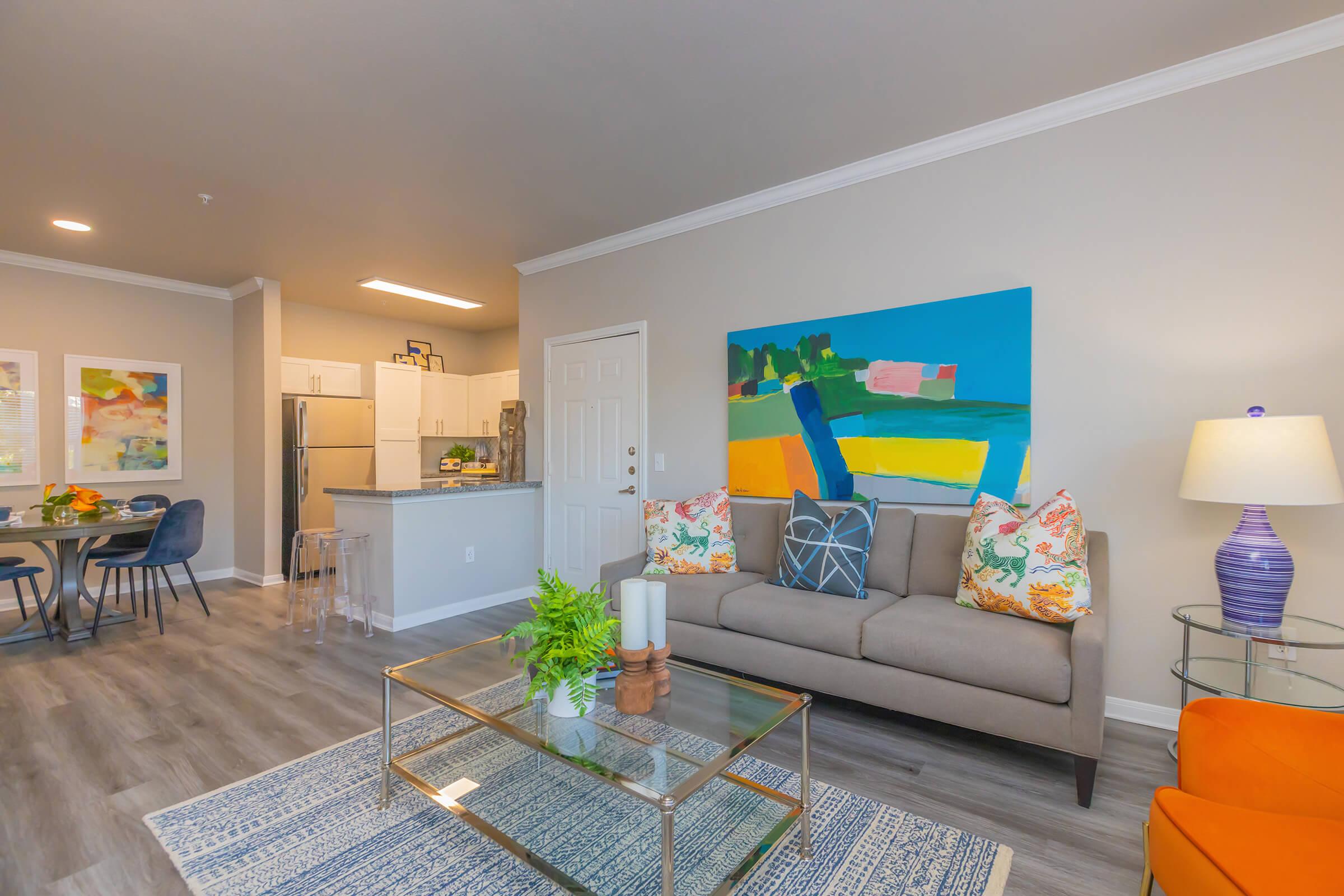 a living room filled with furniture and a flat screen tv