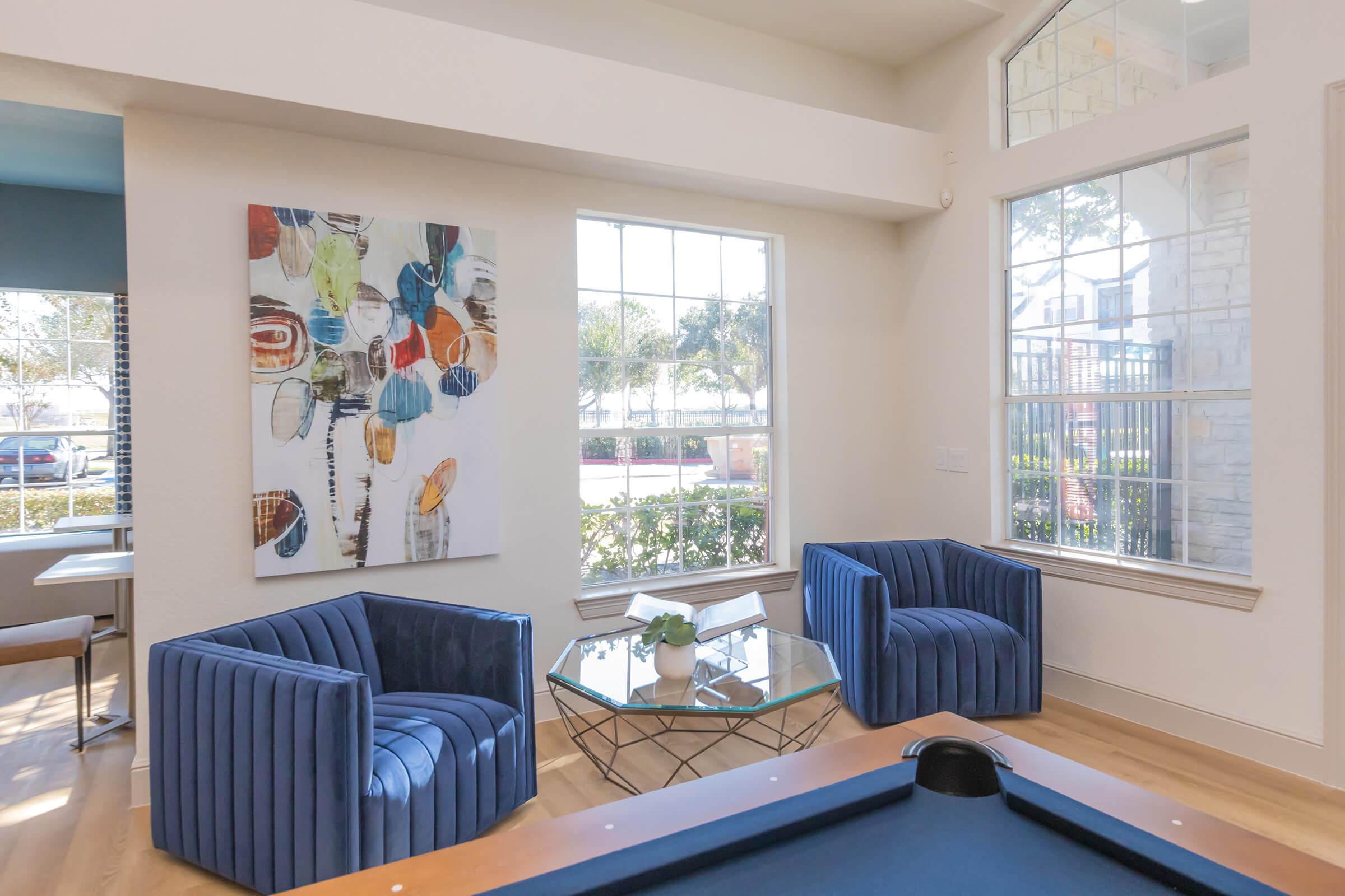 a view of a living room filled with furniture and a large window