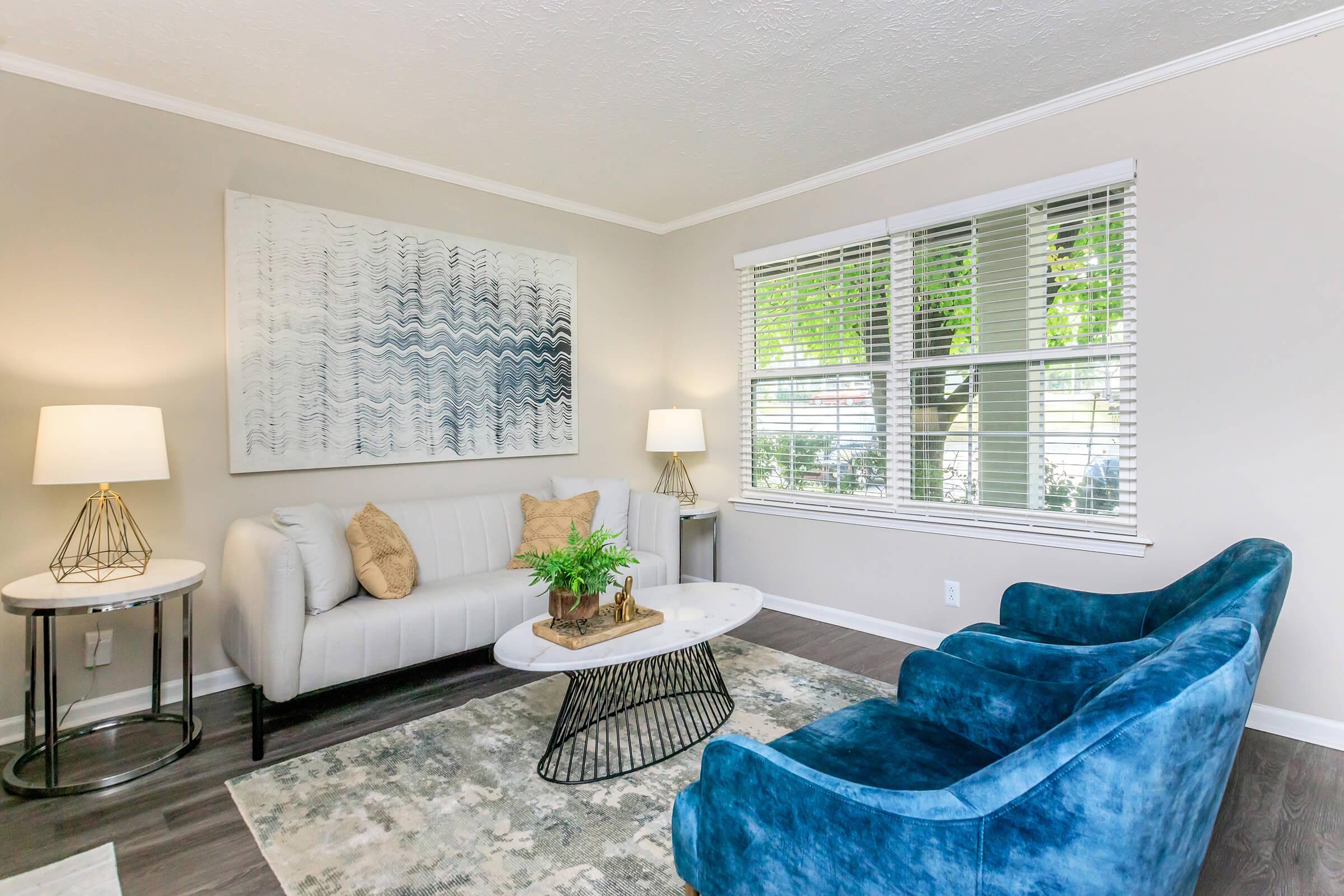 a living room filled with furniture and a window