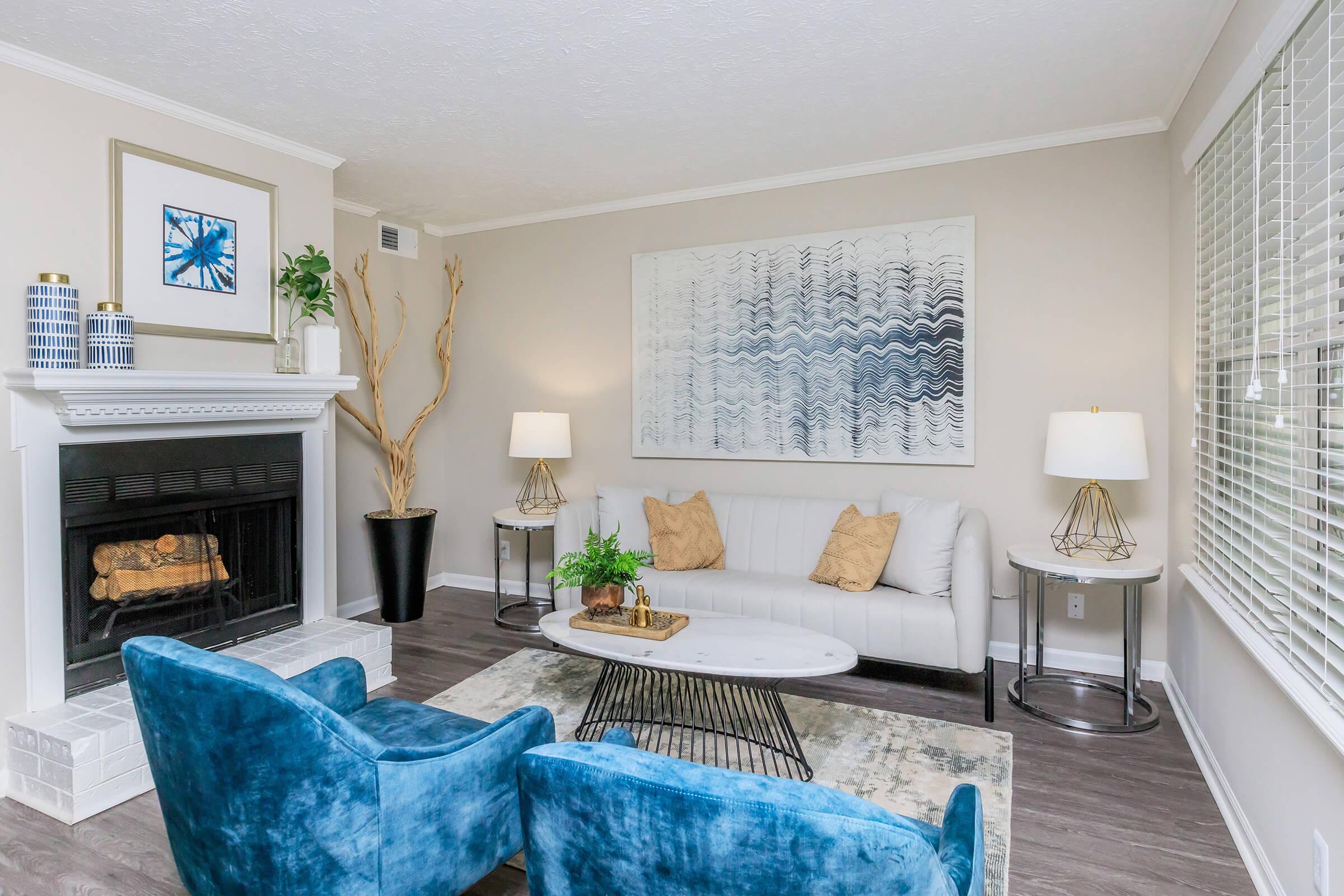 a living room filled with furniture and a fire place