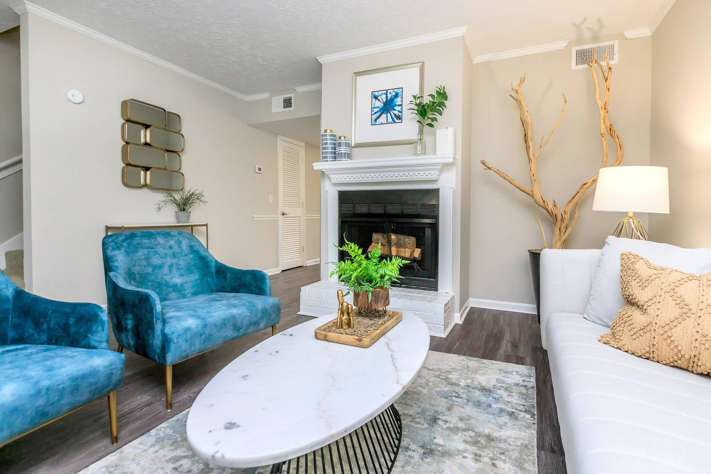 a living room filled with furniture and a fireplace