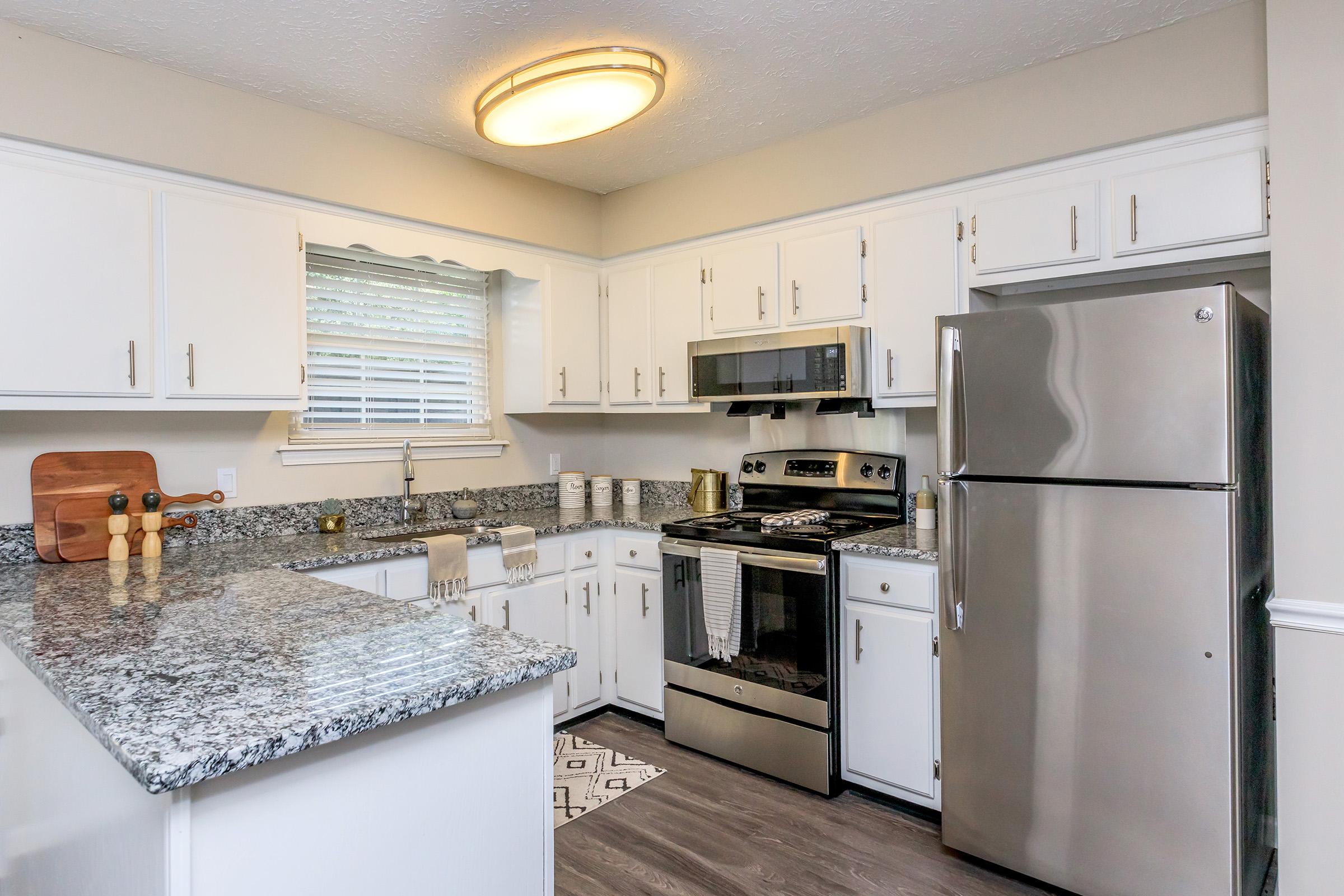 a kitchen with a stove and a refrigerator