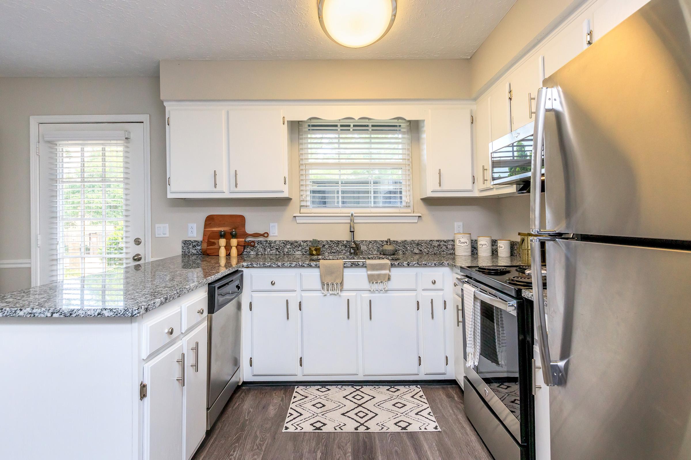 a kitchen with a stove sink and refrigerator