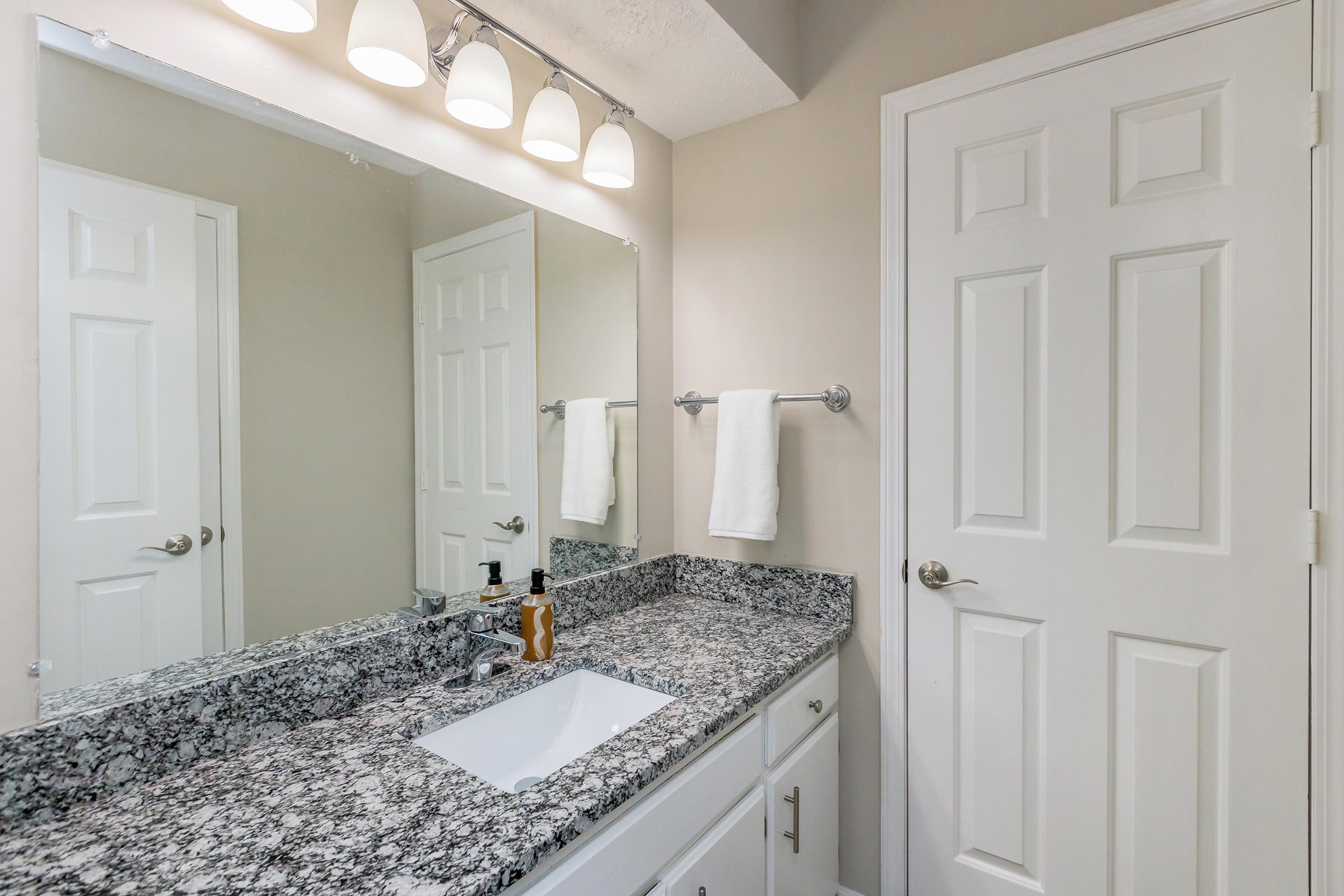 a kitchen with a sink and a mirror