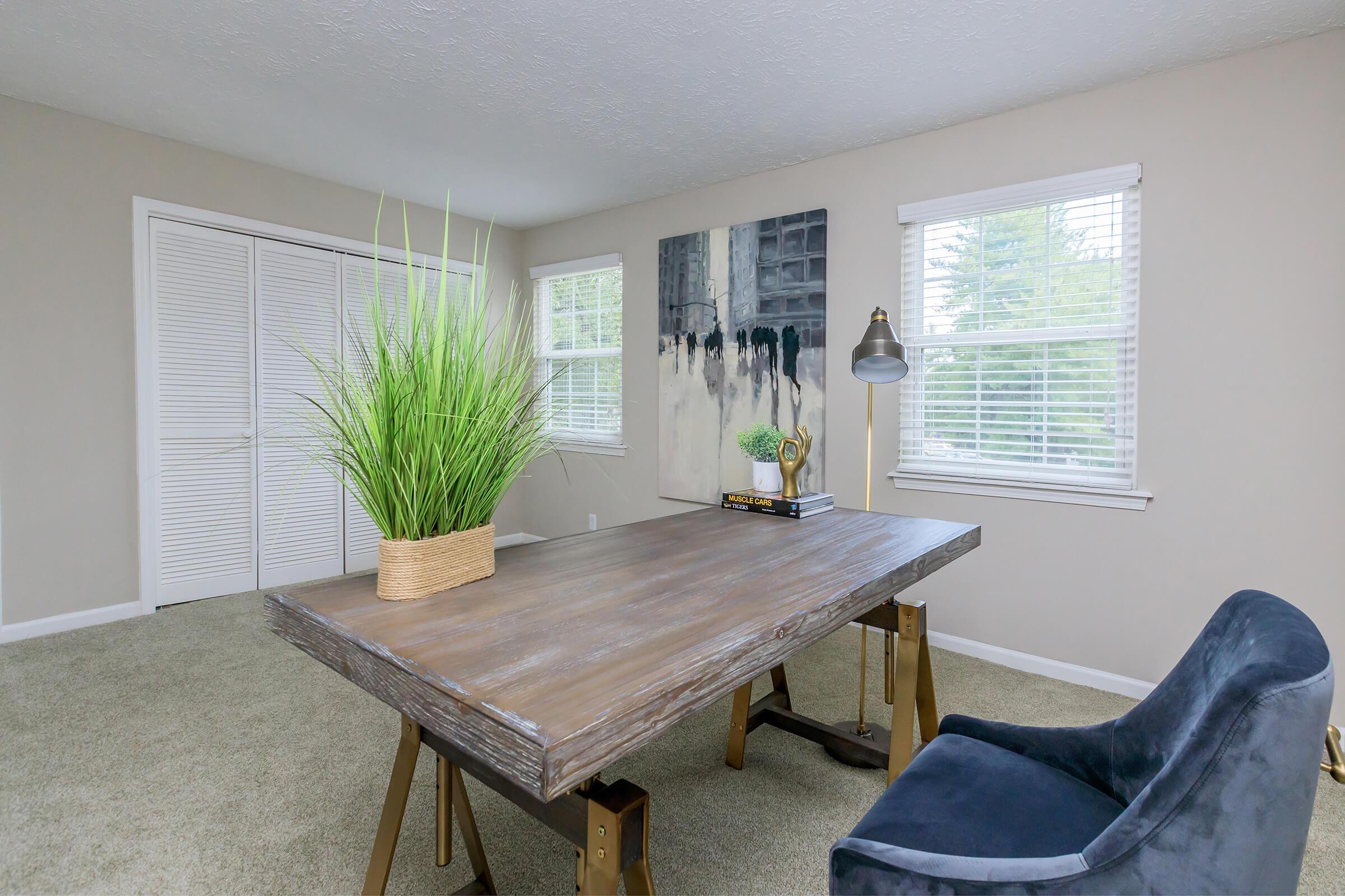 a living room filled with furniture and vase on a table