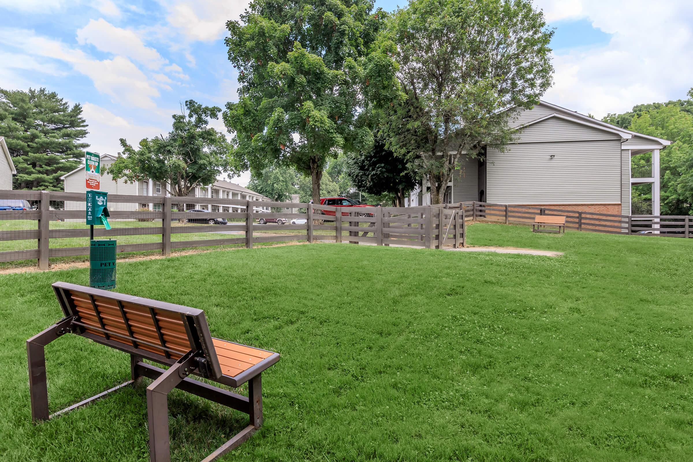 a couple of lawn chairs sitting on top of a grass covered field