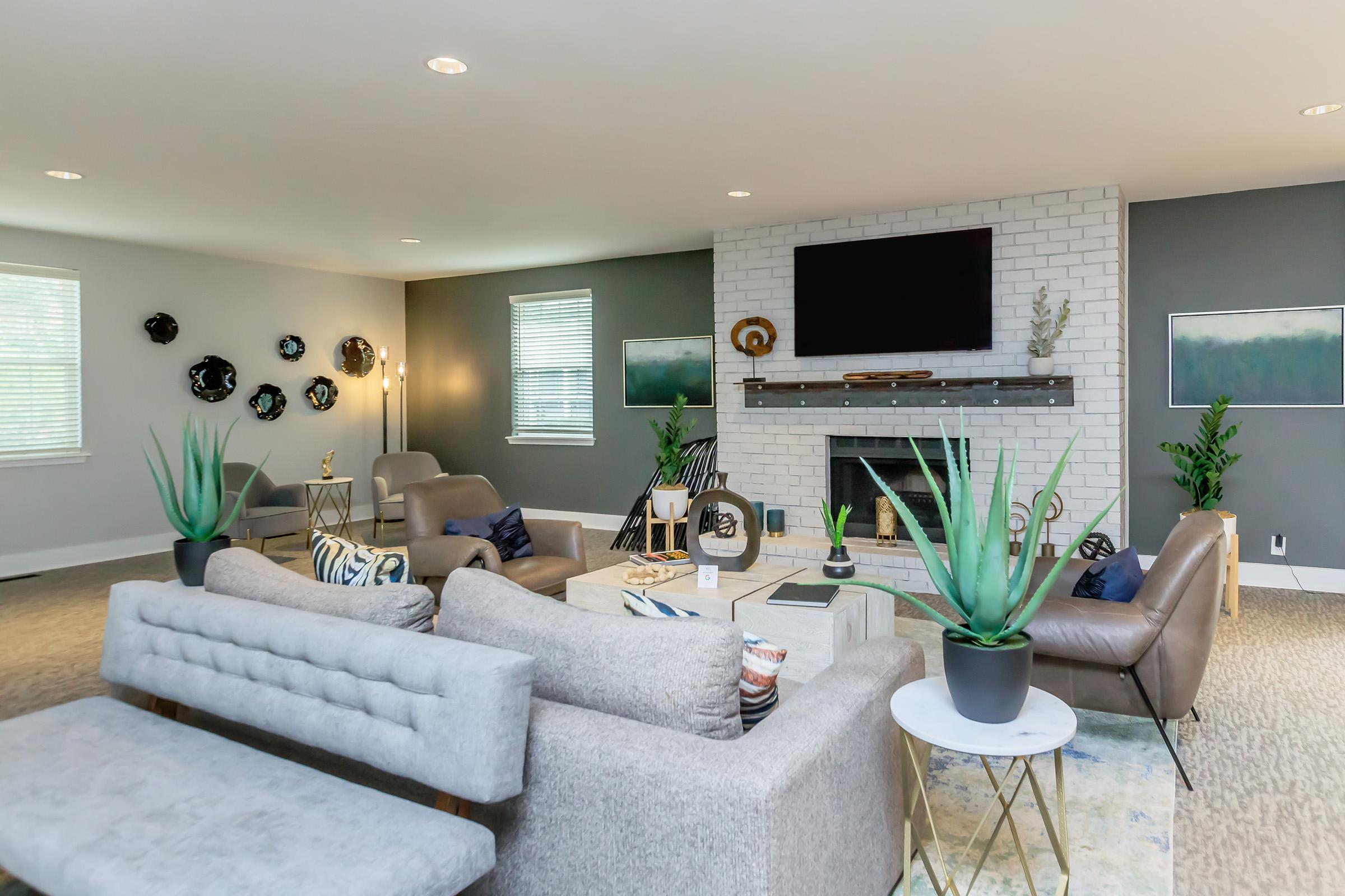 a living room filled with furniture and a large window