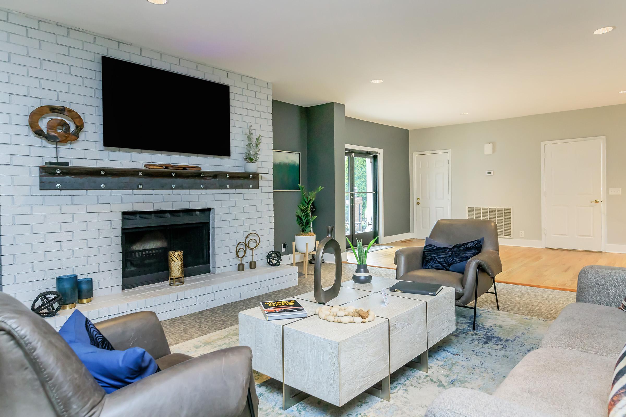 a living room filled with furniture and a fire place