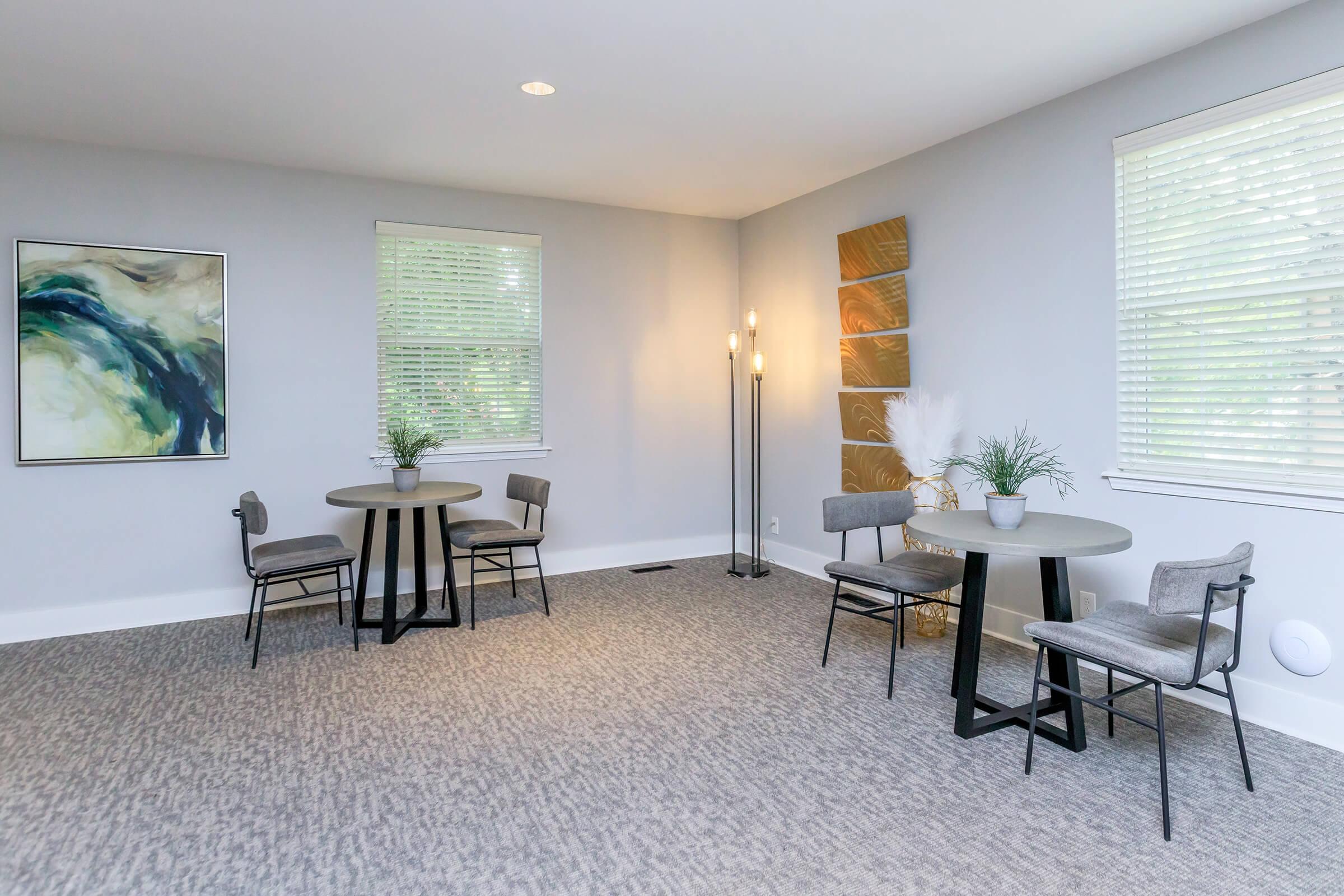 a living room filled with furniture and a large window