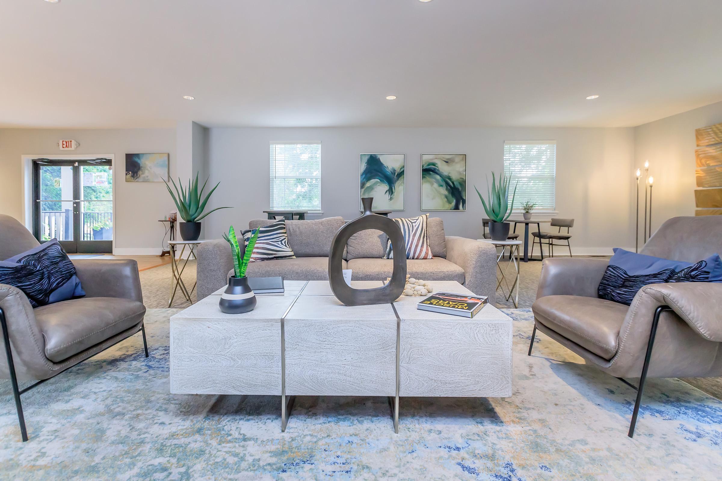 a living room filled with furniture and a large window