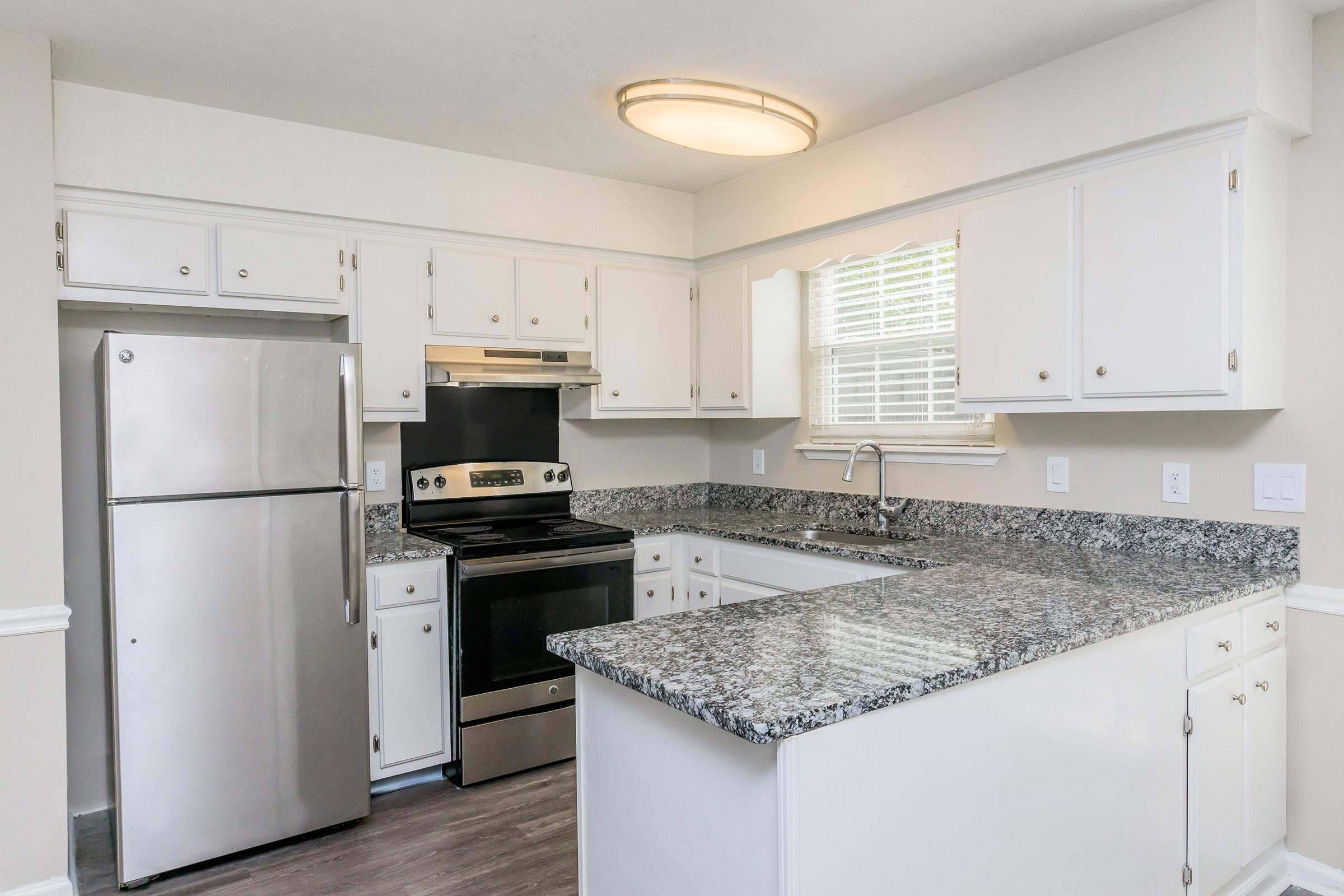 a kitchen with a stove sink and refrigerator