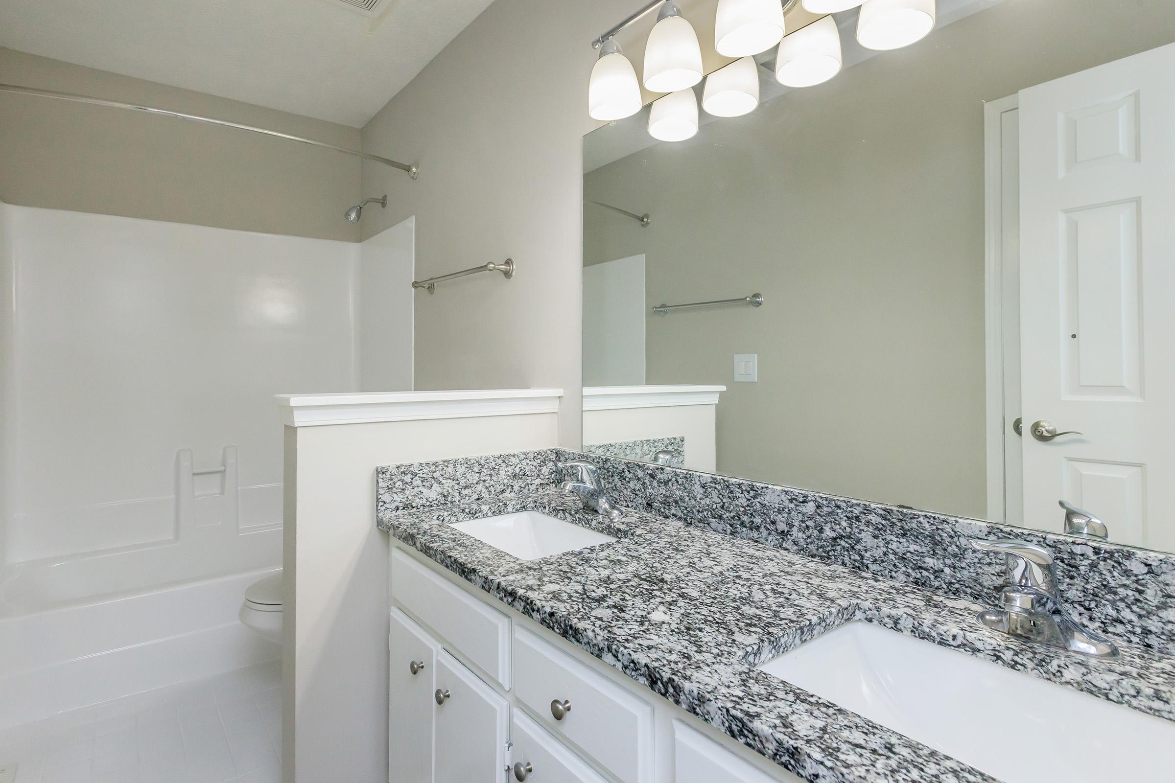 a kitchen with a sink and a mirror