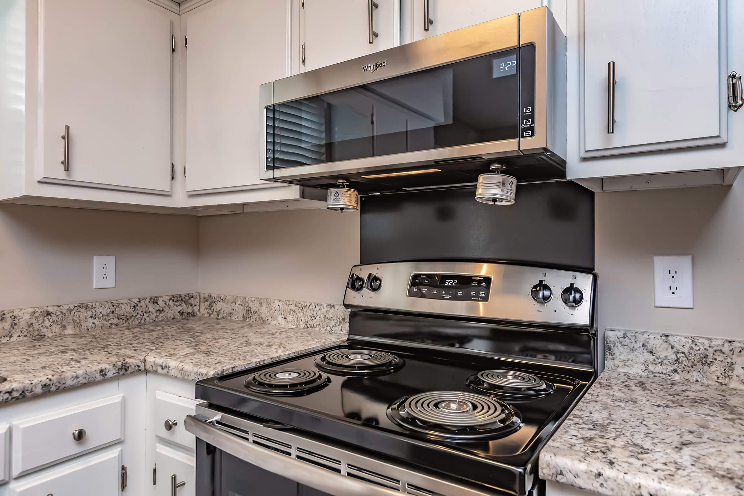 Microwave and range in kitchen of two bedroom townhome