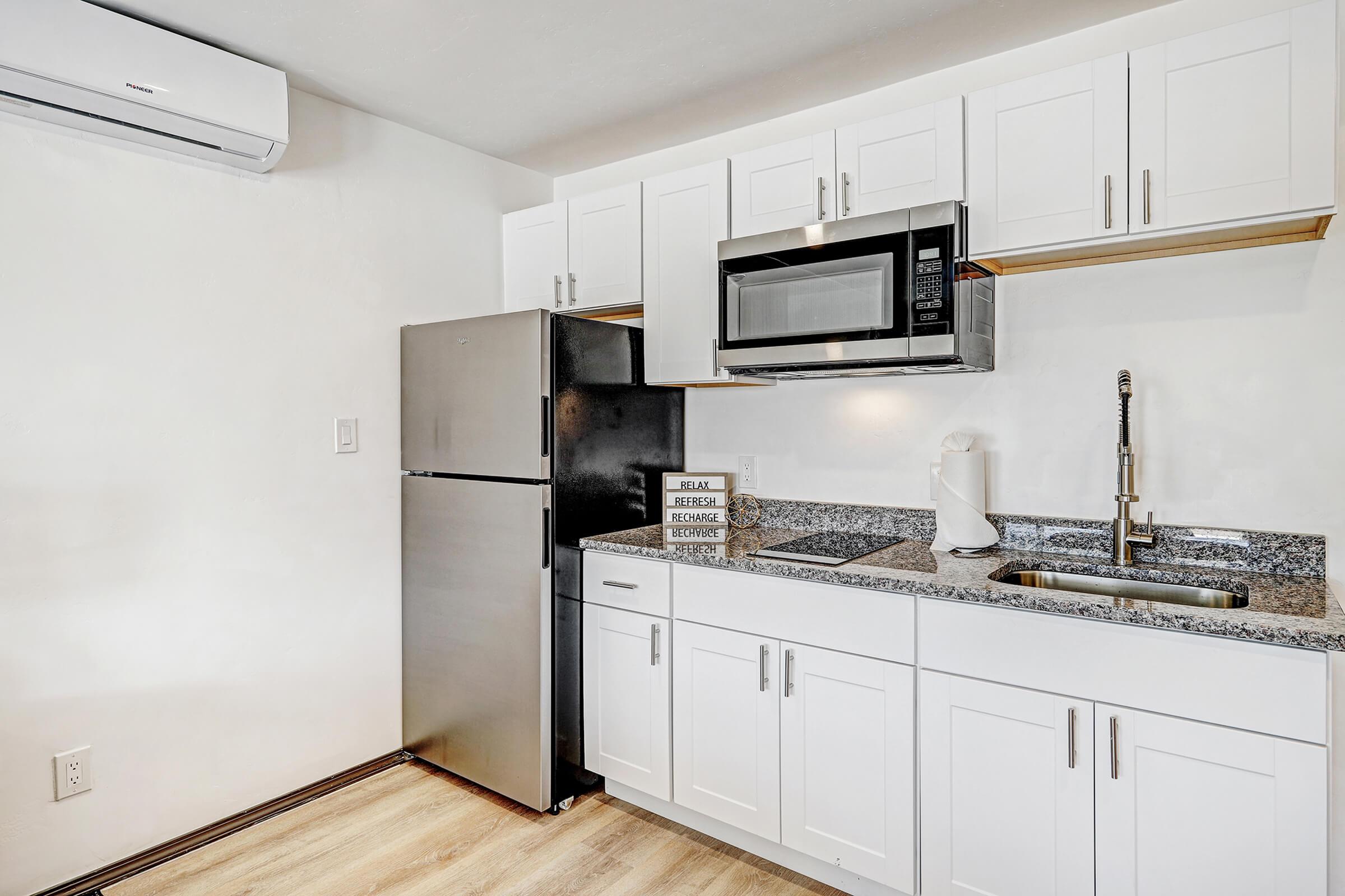 a kitchen with a sink and a refrigerator