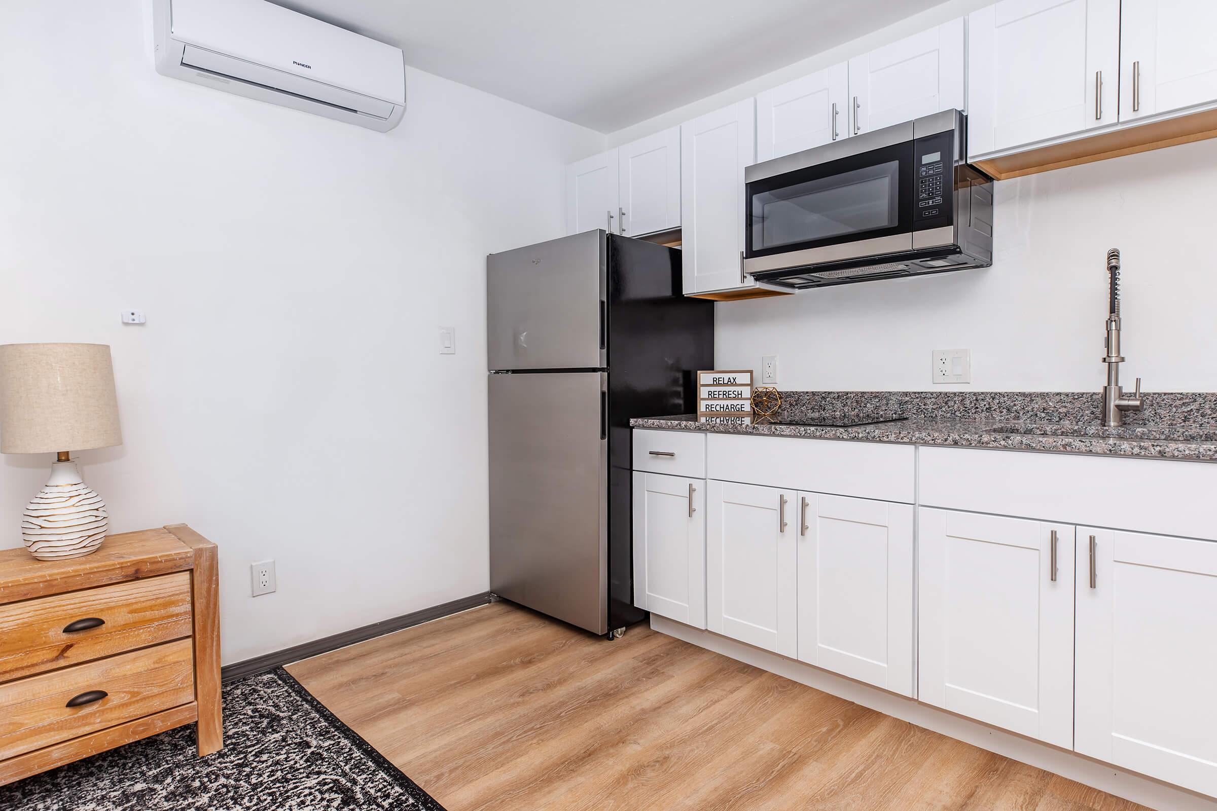 a kitchen with wooden cabinets