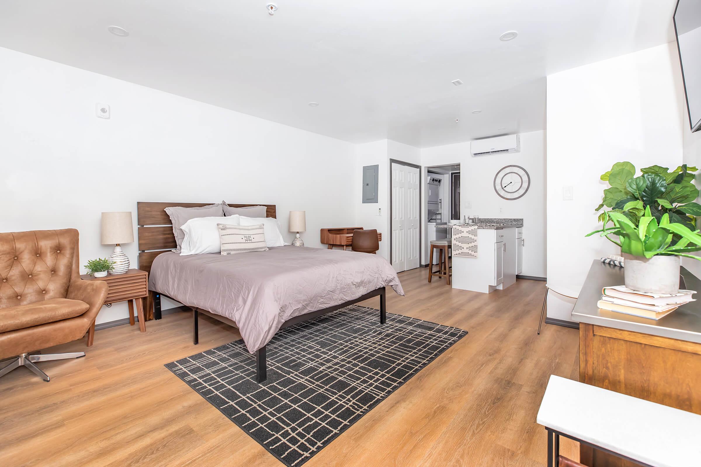 a living room filled with furniture and a bed