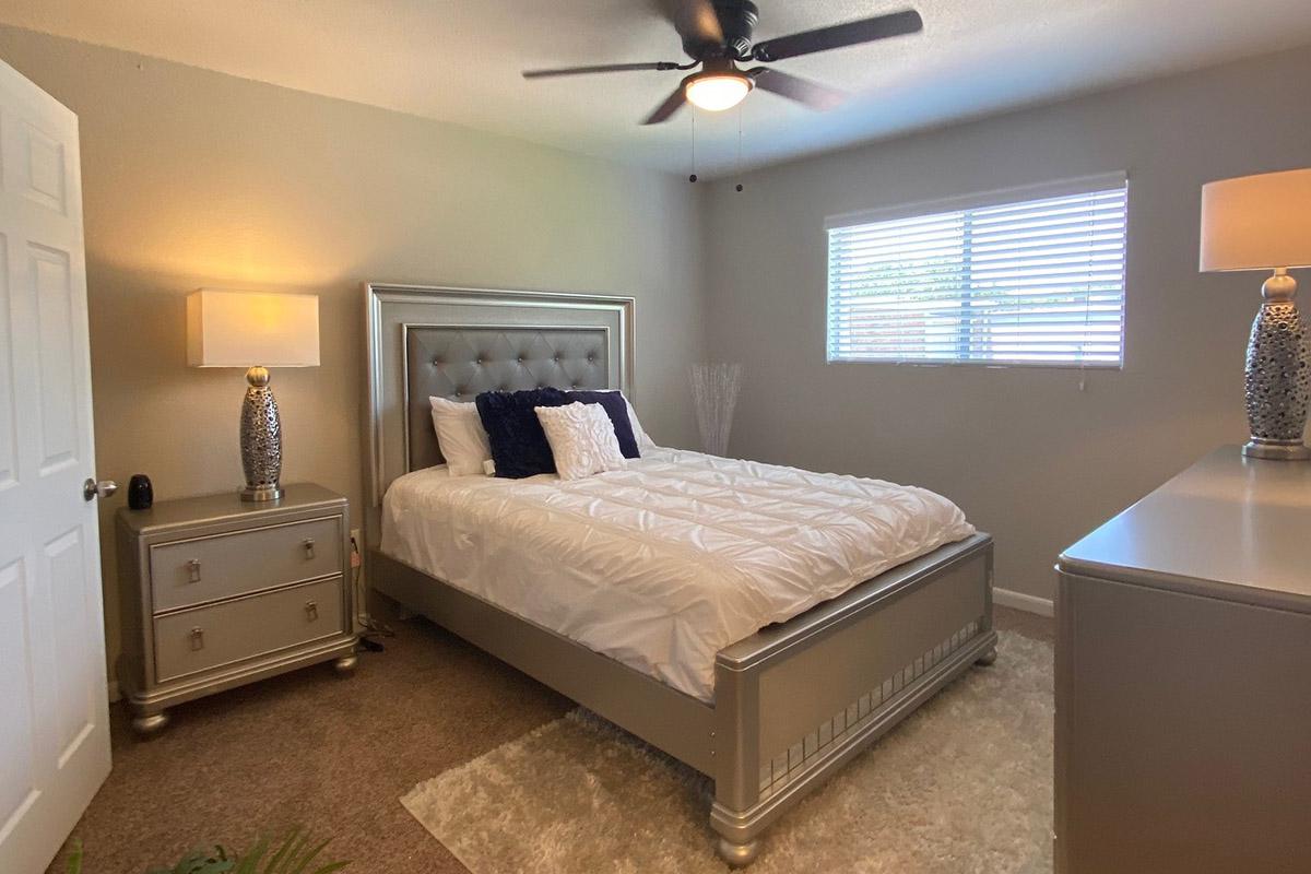 a bedroom with a bed and desk in a room