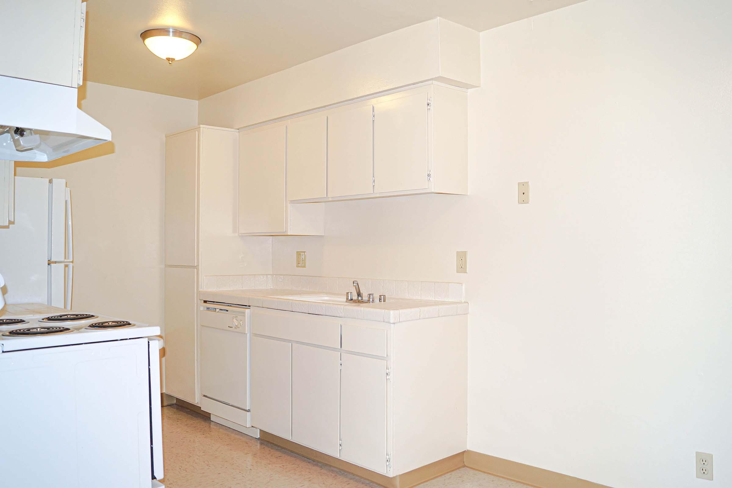 a kitchen with a stove and a refrigerator