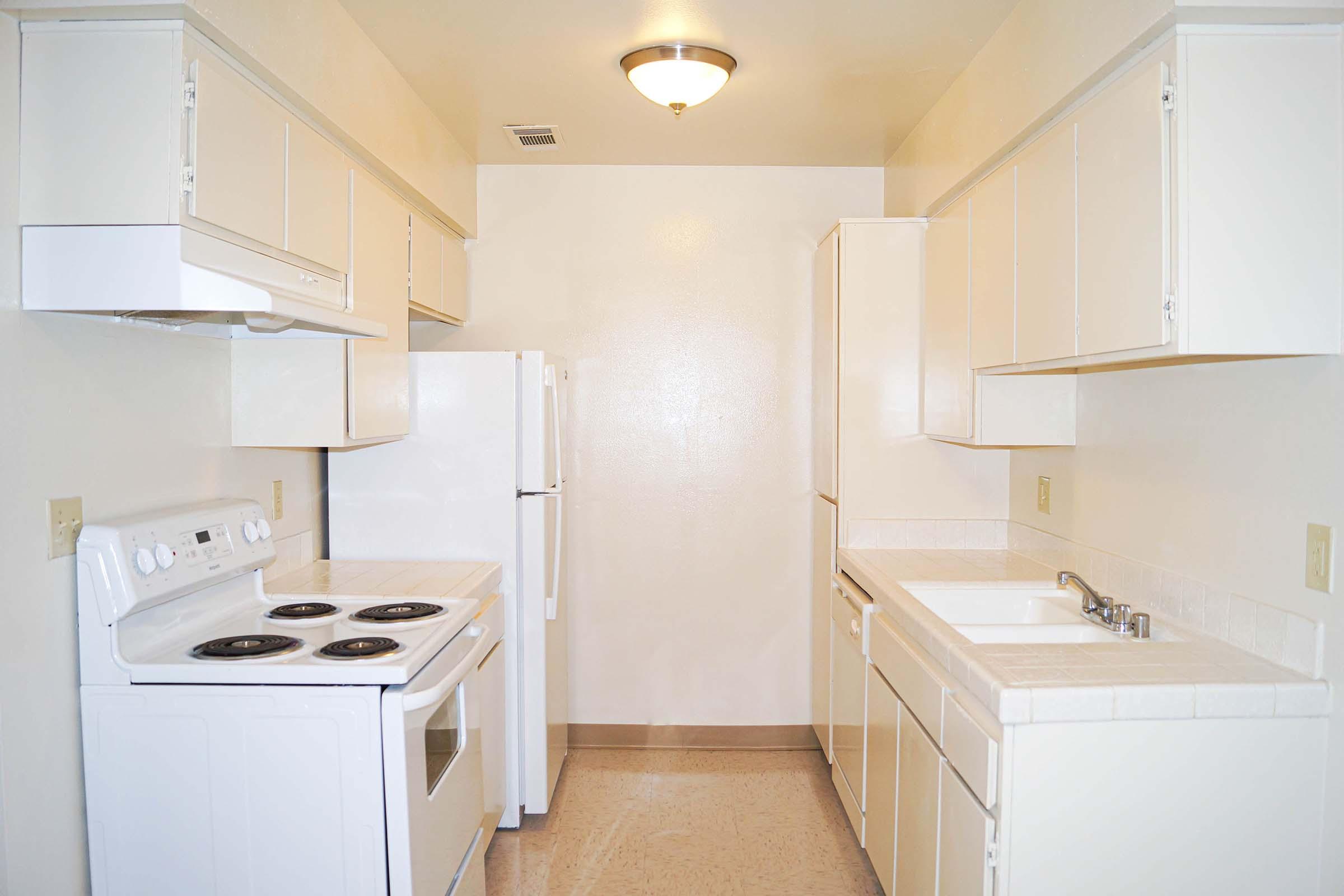 a kitchen with a sink and a refrigerator