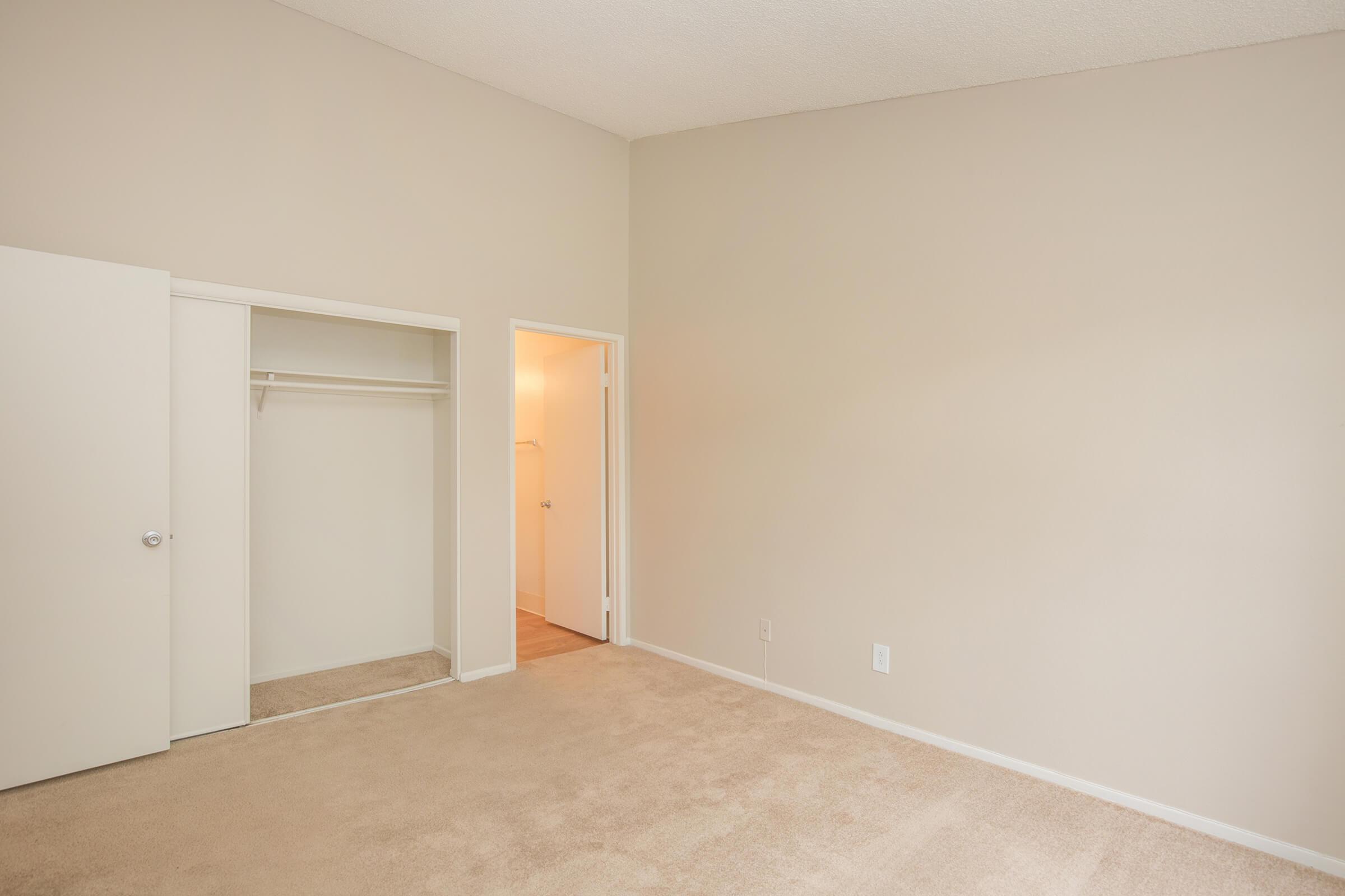 Bedroom with open sliding closet doors