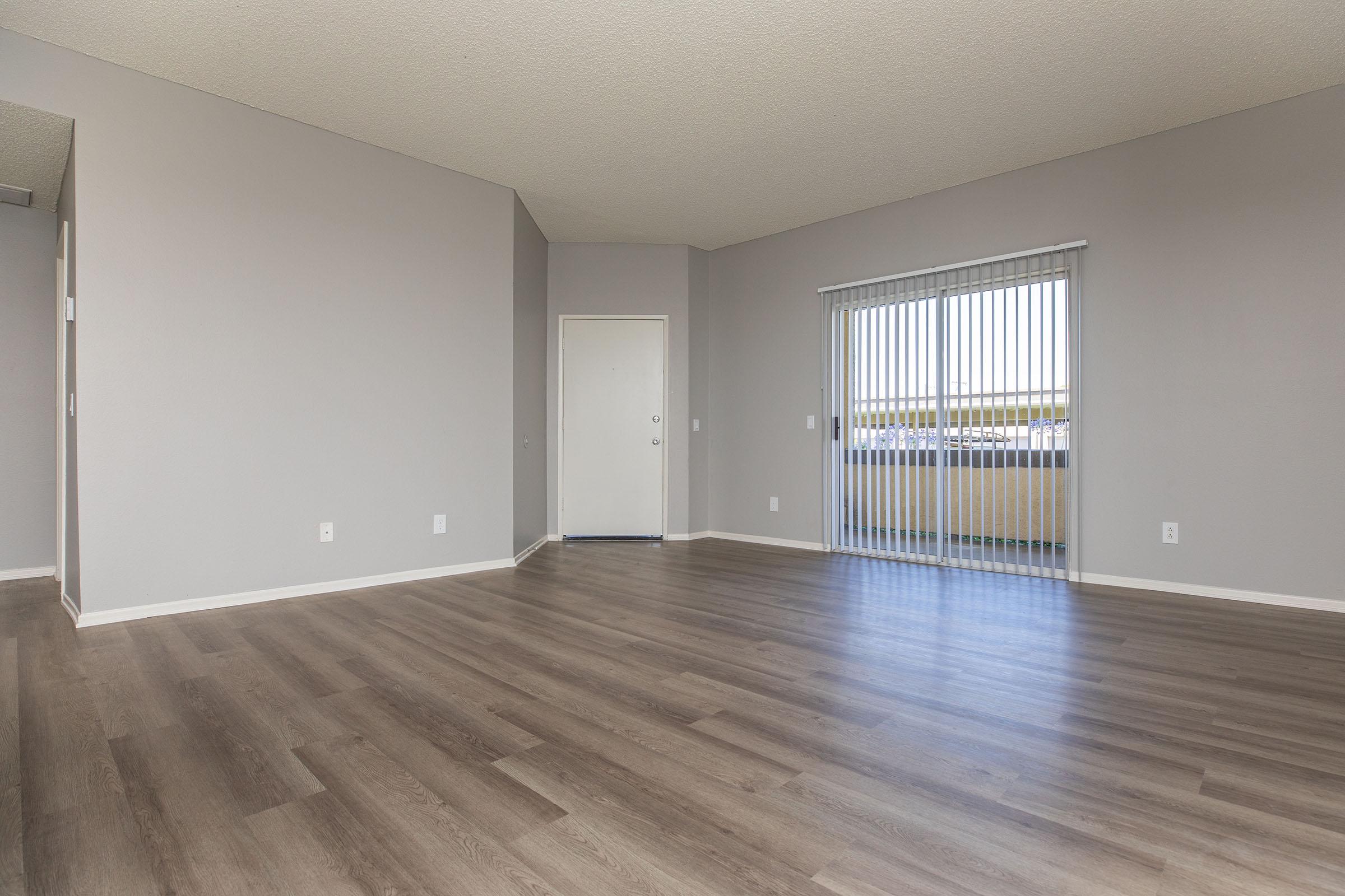 a large empty room with a wooden floor