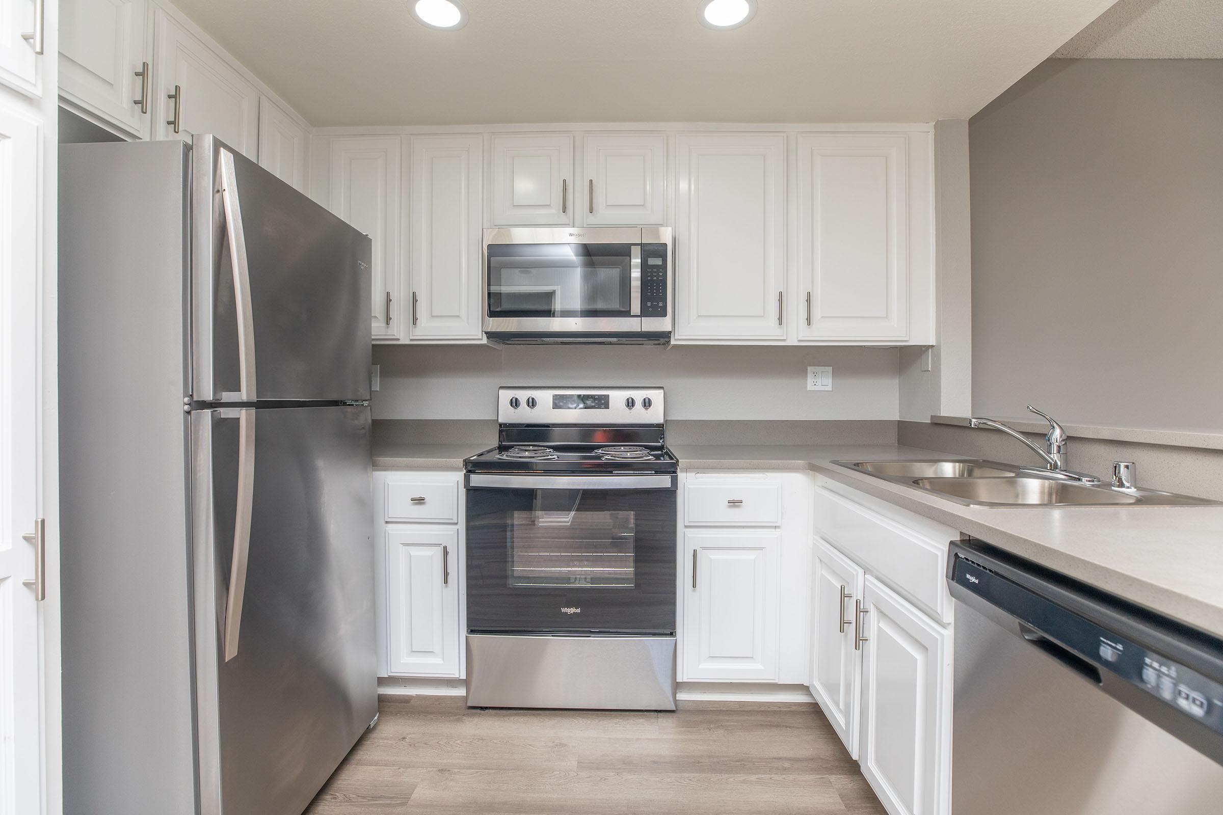 a kitchen with a stove and a refrigerator