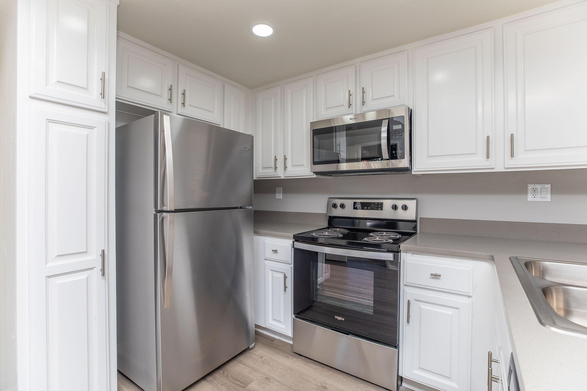 a kitchen with a stove top oven sitting inside of a refrigerator