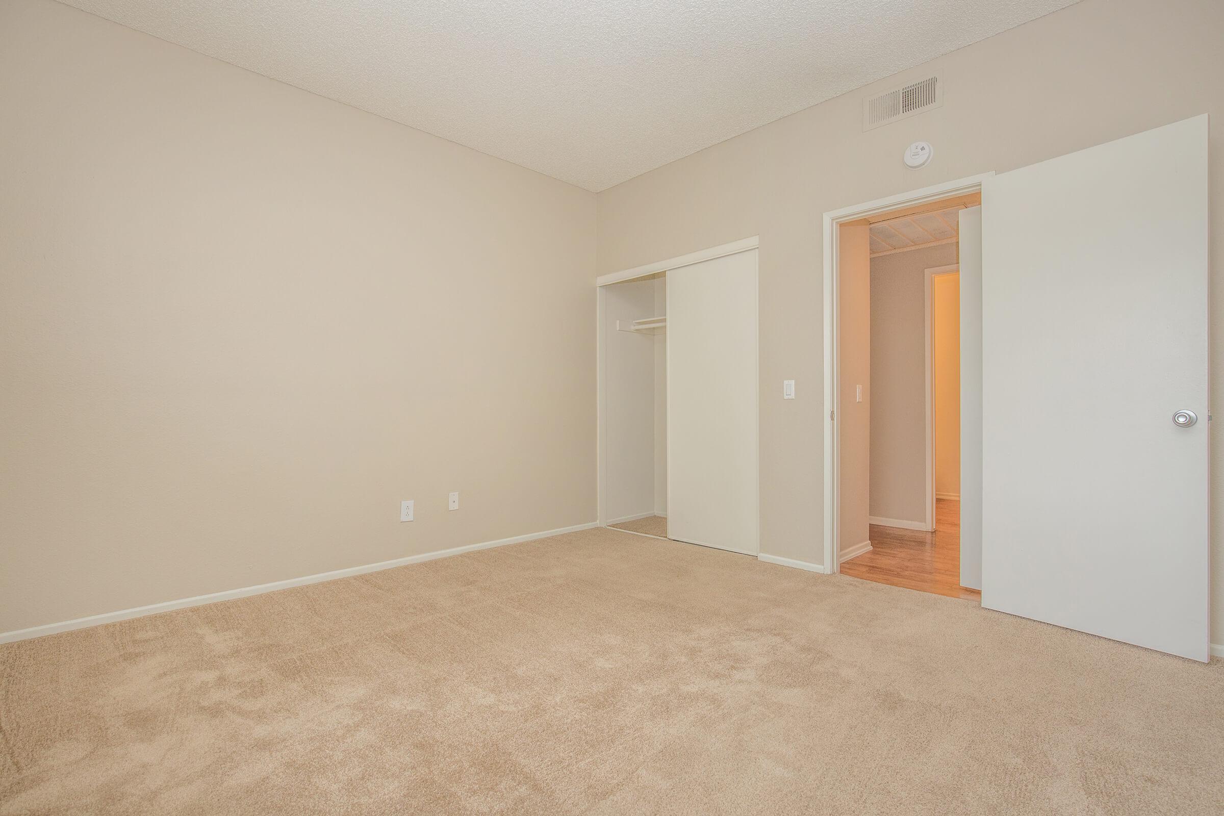 Bedroom with open sliding closet door