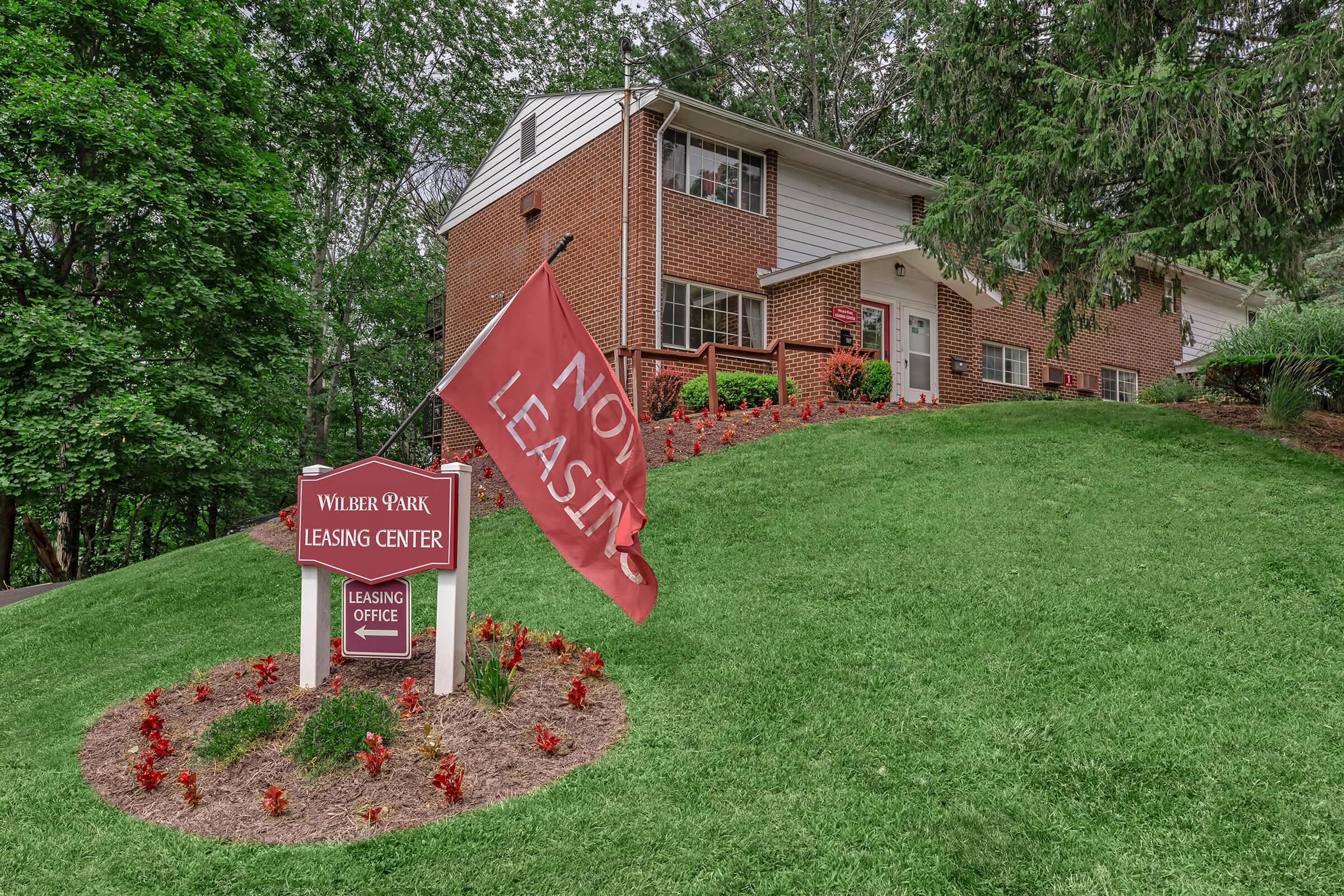 a sign sitting on top of a grass covered field