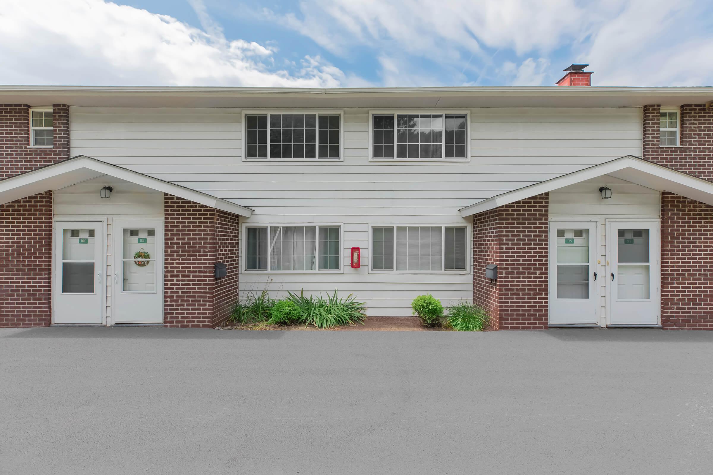 an empty parking lot in front of a house