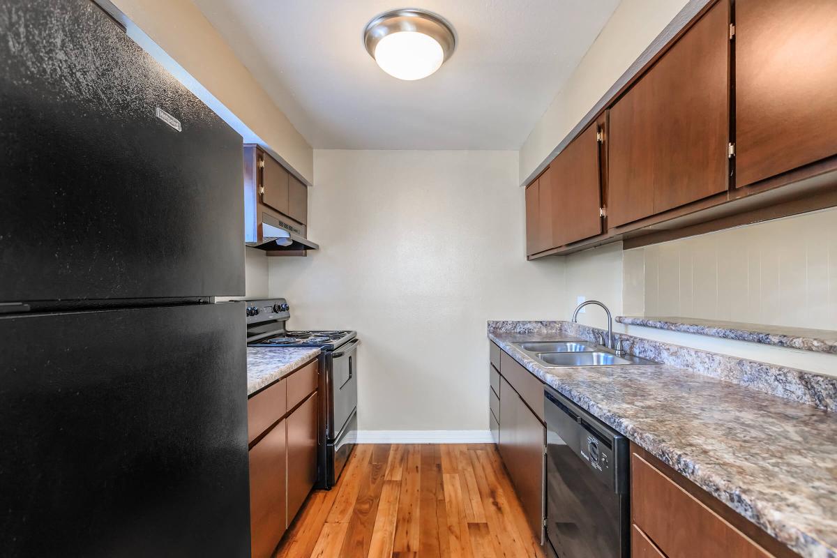 a modern kitchen with stainless steel appliances and wooden cabinets