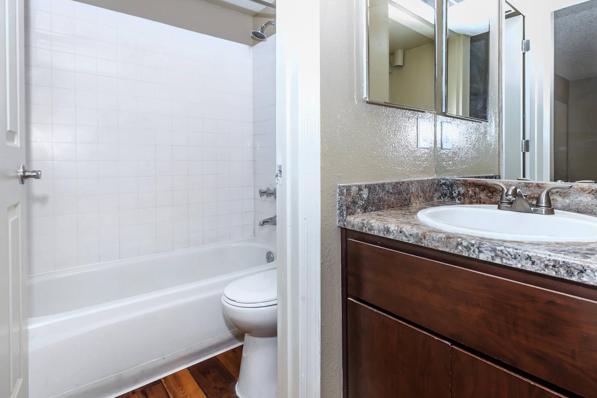 a large white tub sitting next to a sink