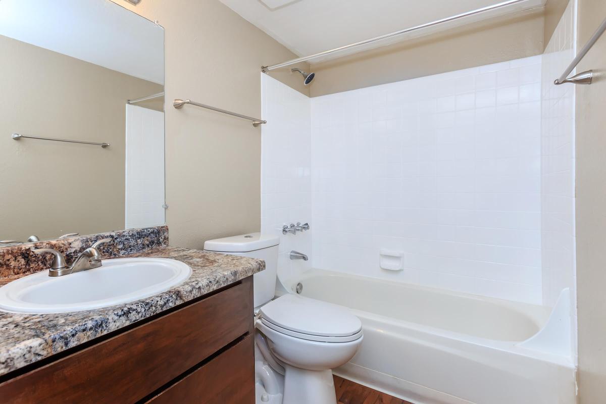 a large white tub next to a sink