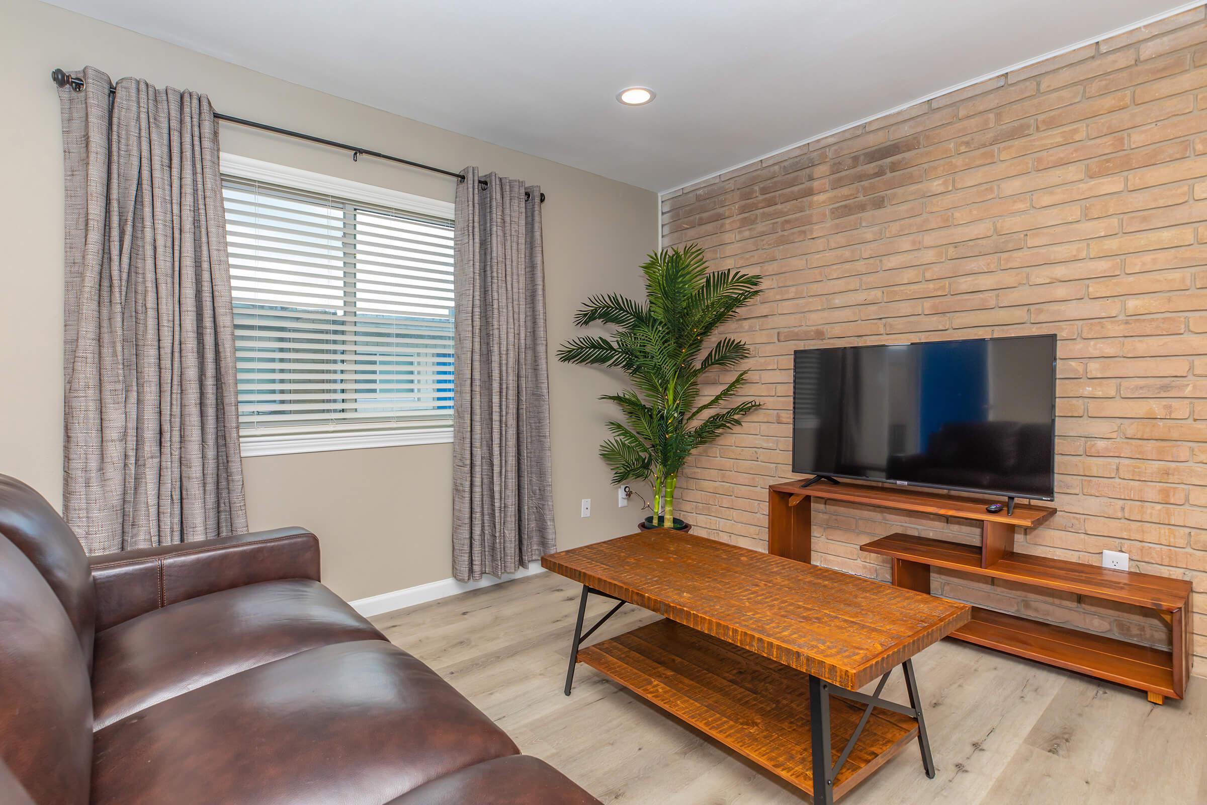 a living room filled with furniture and a flat screen tv