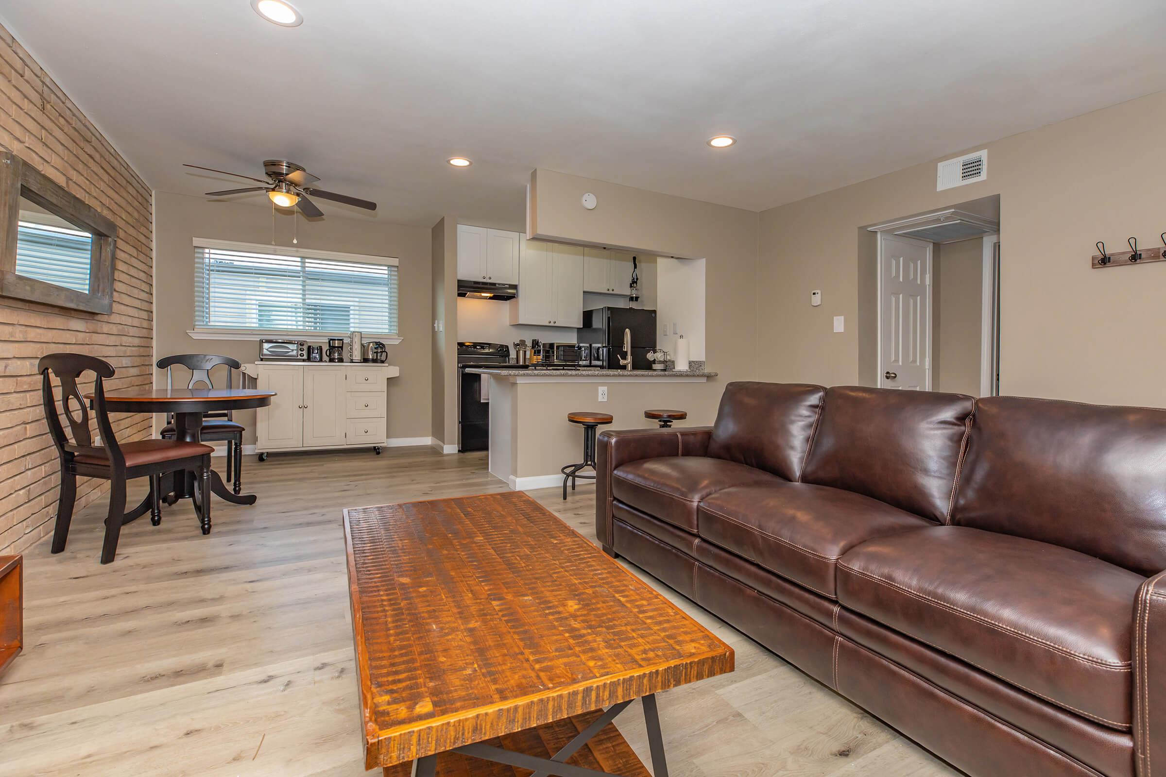 a living room filled with furniture on top of a wooden table