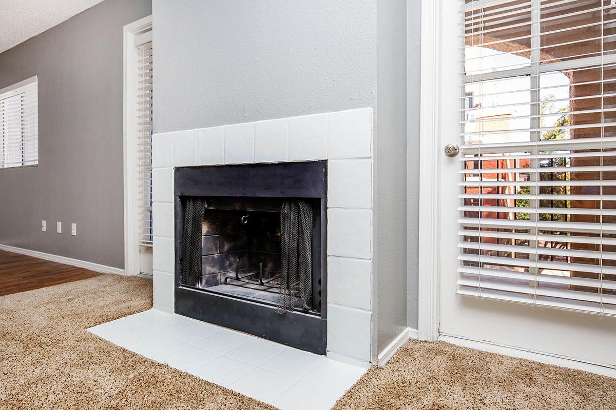 a room with a fireplace and a large window