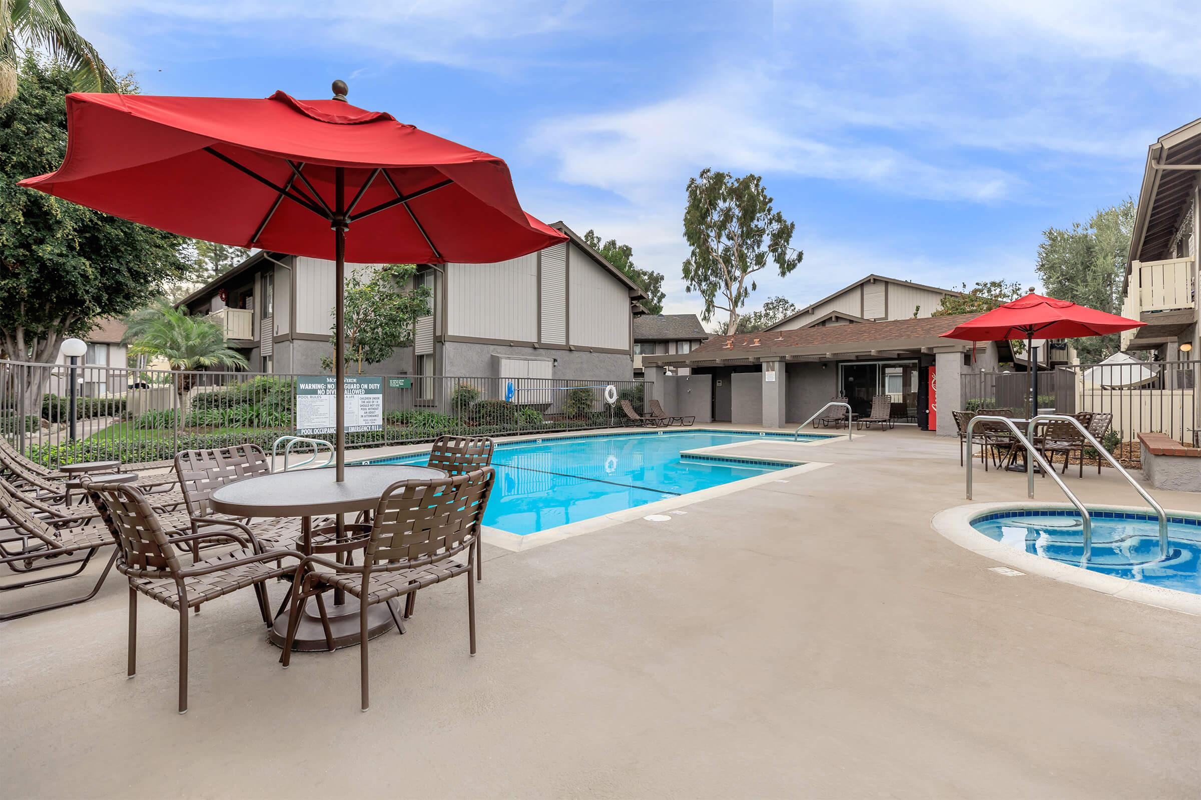 The community pool and the community spa with tables and chairs