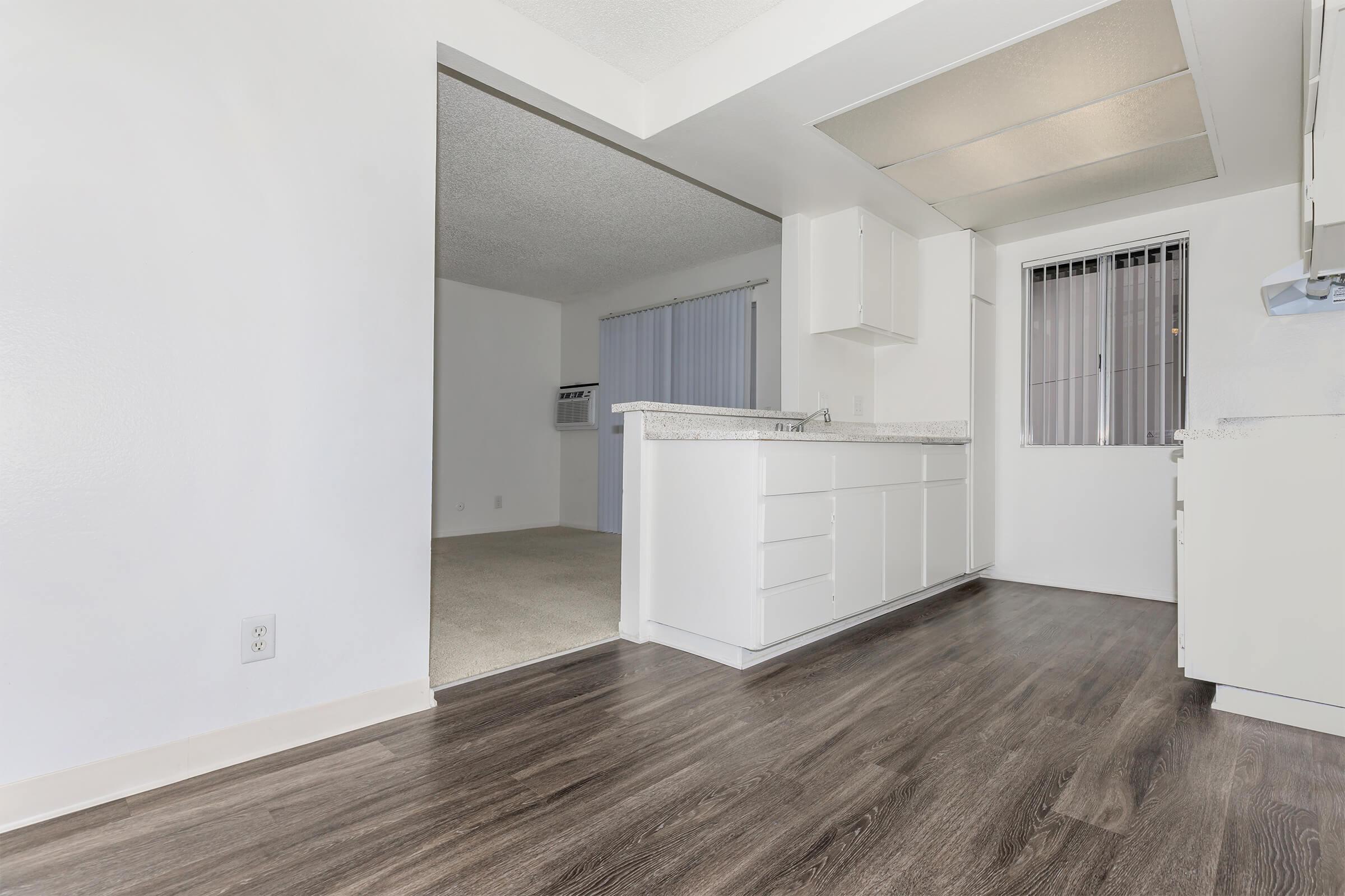 Dining room and kitchen with wooden floors