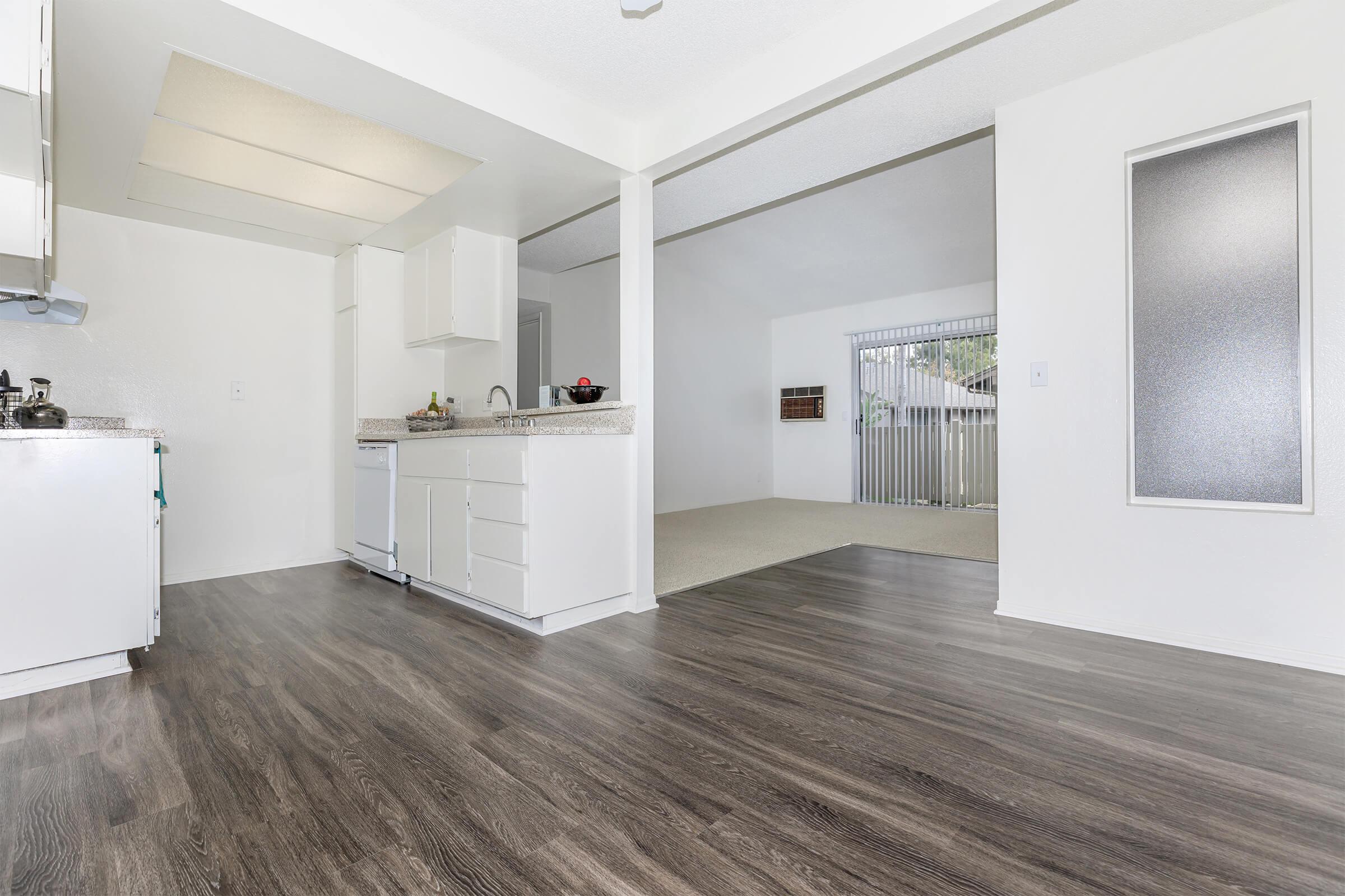 Unfurnished dining room and kitchen with wooden floors